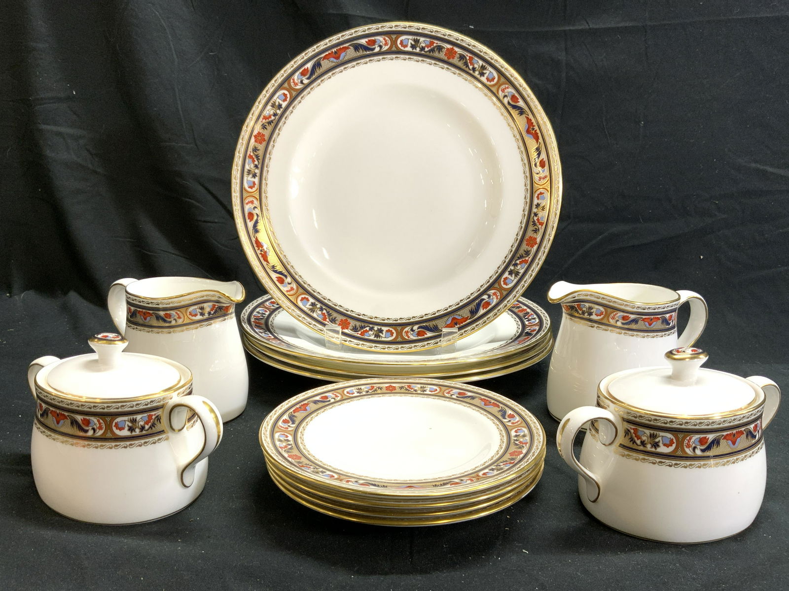 ROYAL CROWN DERBY CHARDONNAY Lot 12 Bone China: Undersides of each piece reads ROYAL CROWN DERBY CHARDONNAY. Lot includes 4 dinner plates, 4 saucers, 2 creamers, & 2 sugar dishes. Each piece has intricate multi toned floral, leaf motif detail aroun