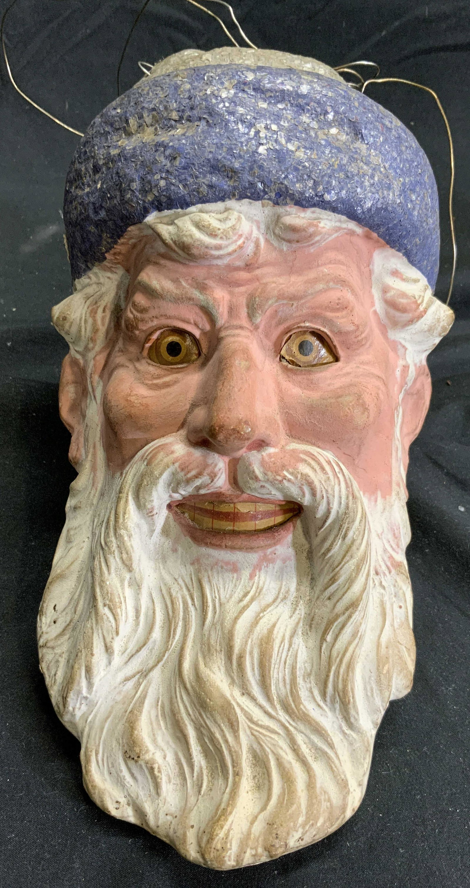 Vintage Resinous Male Head Wall Hanging Figure: Piece depicts and elderly bearded male figure wearing hat. Piece appears to be a lightweight resinous material. Figure has wire to hang piece from. Measures approx 9 inches tall 5 inches wide & deep w