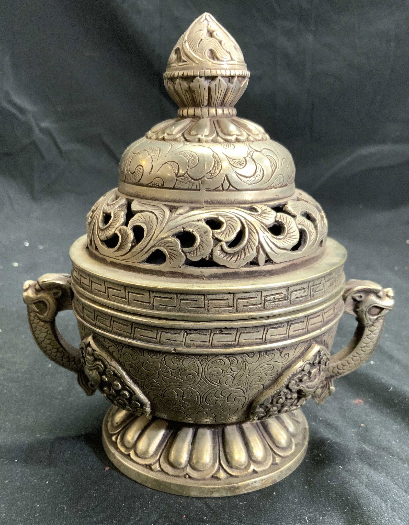 Vintage Asian Pewter Incense Burner W Lid: Incense burner is silver toned and pewter. Piece has lid with pierced detail. Piece has dragon detailed handles. Lid has pierced detail in addition to scrolled detail. Incense burner is footed, piece 