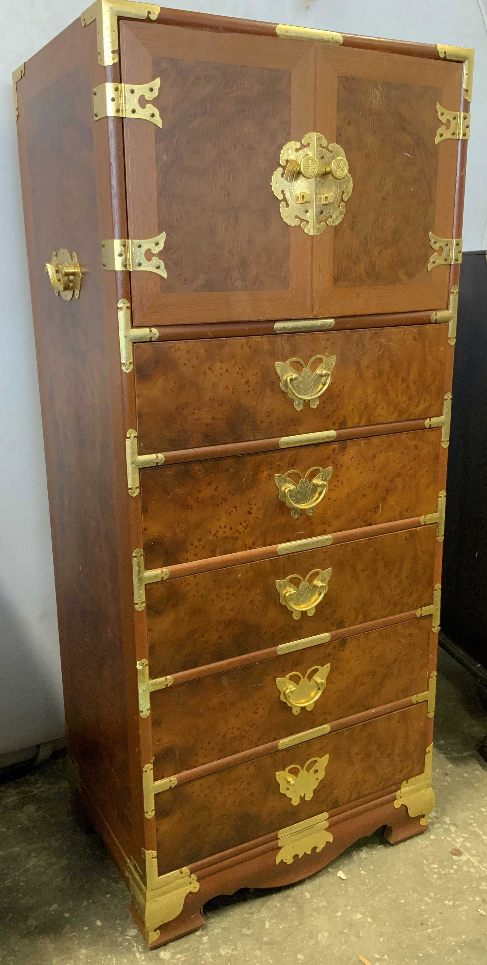 Vintage Empire / Campaign Style Lingerie Chest: Lingerie chest is vintage possibly antique, campaign style. Chest has 10 drawers, each with hand dovetailing. Piece is light brown with gold toned hardware and adornments Measures approx 52 inches tal