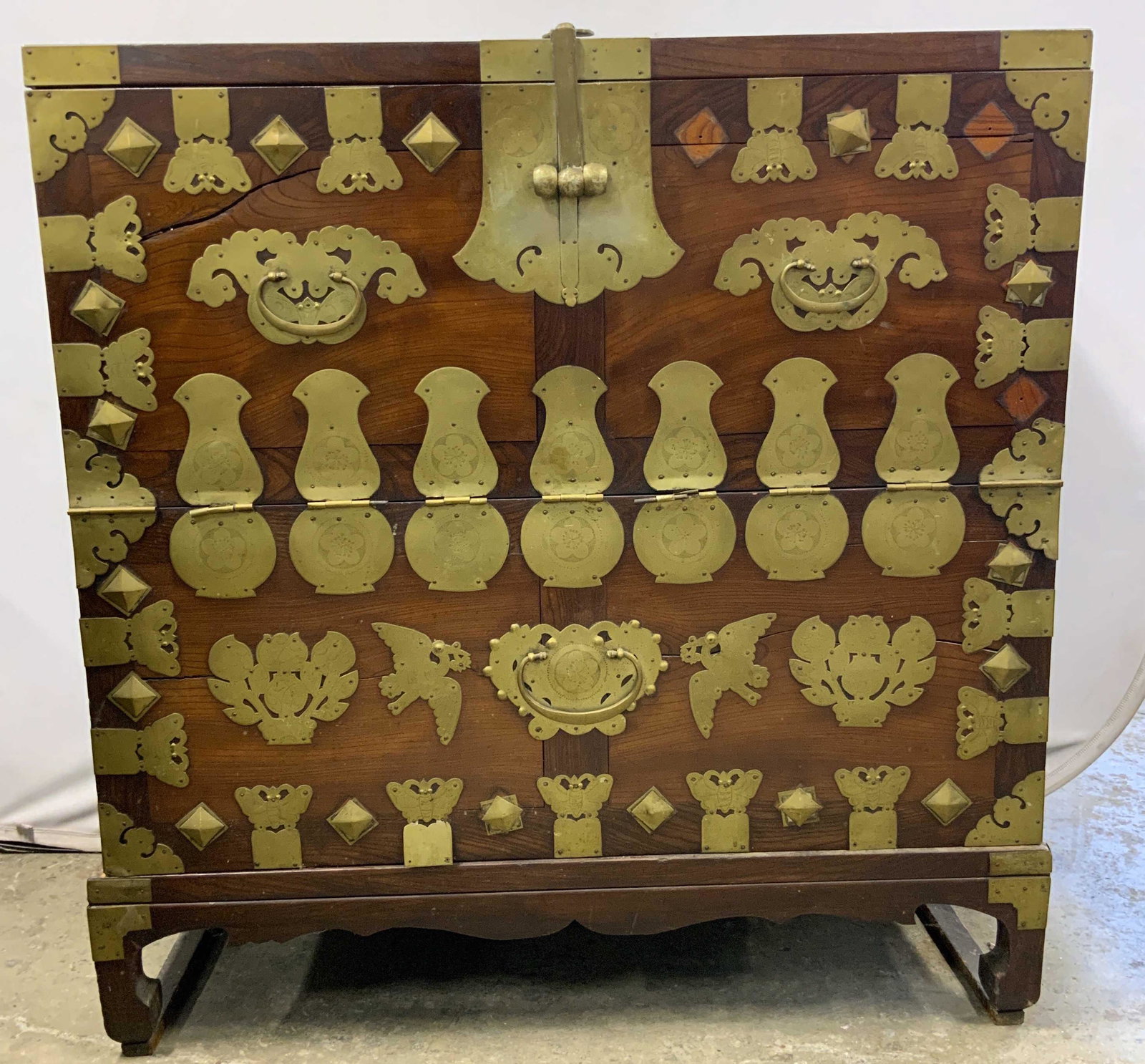Vintage Empire Style Chest W 3 Drawers: Chest is vintage possibly antique. Piece is brown toned & wooden with gold toned brass hardware & adornments. Chest has flip open door and chow feet. Measures approx 41 inches long 43 inches tall 19 i