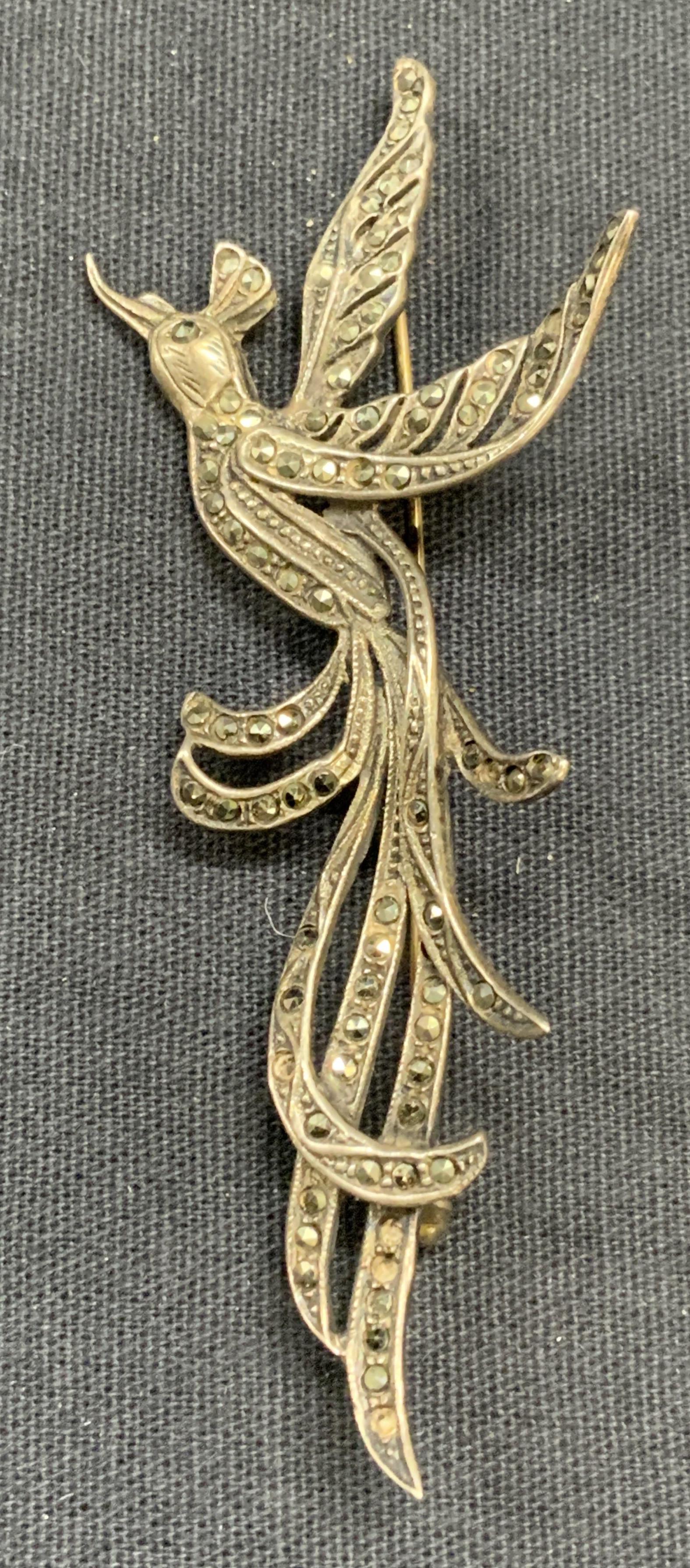 Sterling Slvr & Marcasite Bird of Paradise Brooch: Sterling silver and marcasite bird of paradise brooch. Marked silver to underside, tests as sterling. Measures approx. 3.25 x 1.25 inches. Total weight .27 ozt. Surface wear consistent with exposure. 