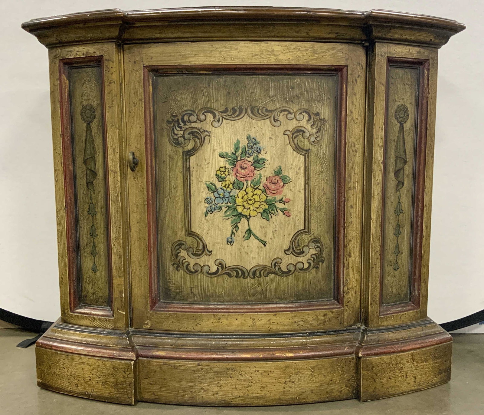 Italian Venetian Painted Wooden Sideboard: Sideboard is vintage and wooden. Piece has painted floral leaf, & scroll detail. Sideboard has brown toned wooden top. Piece has key head style cabinet pull. Sideboard measures approx 35 inches long 3