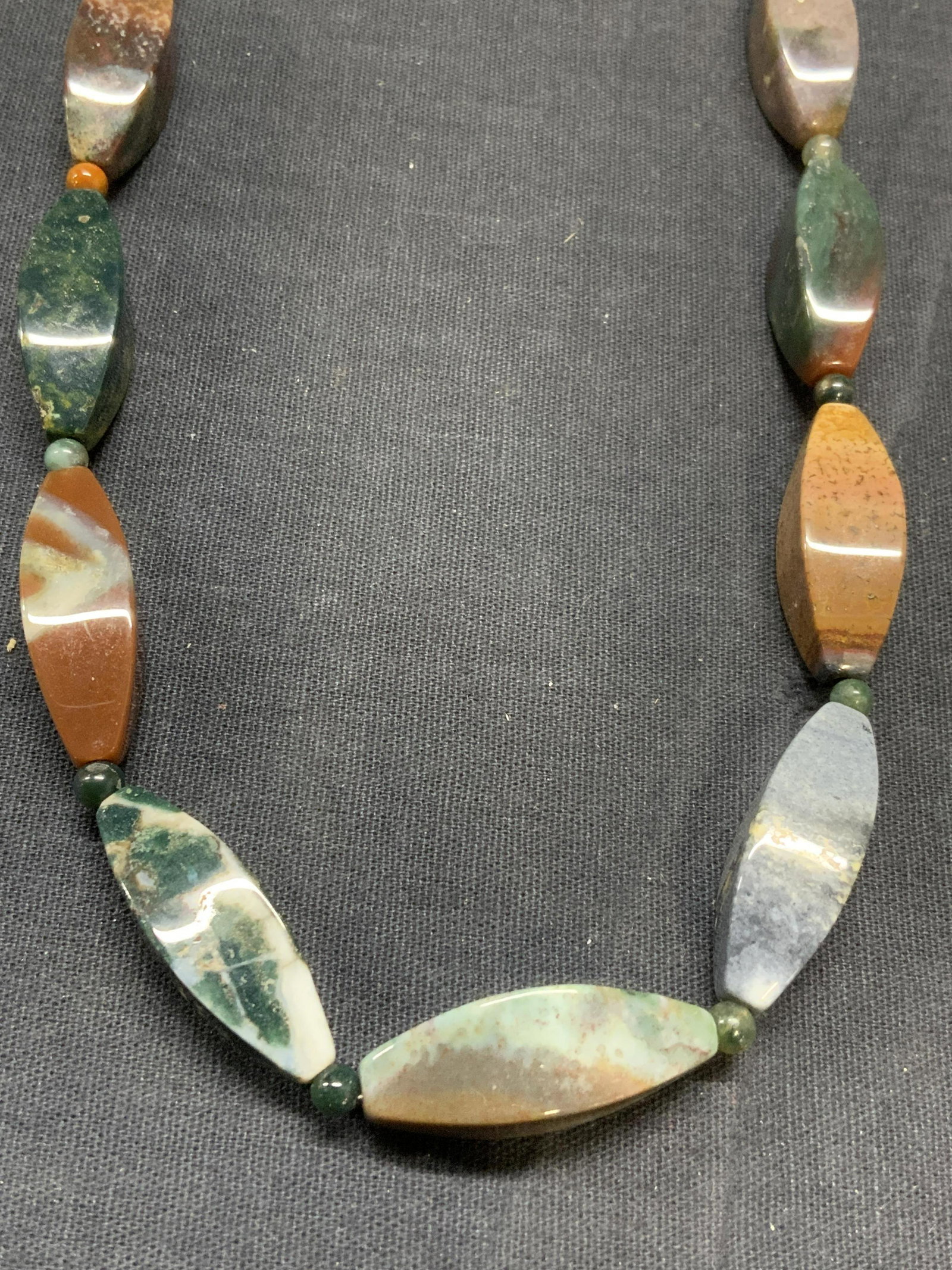 Natural Stone Beaded Choker Necklace: Natural stone beaded choker necklace with sterling silver clasp. Marked 925 on clasp. Measures approx. 18 inches long. Some surface wear consistent with exposure. Total weight 64.9 grams. Estate jewel