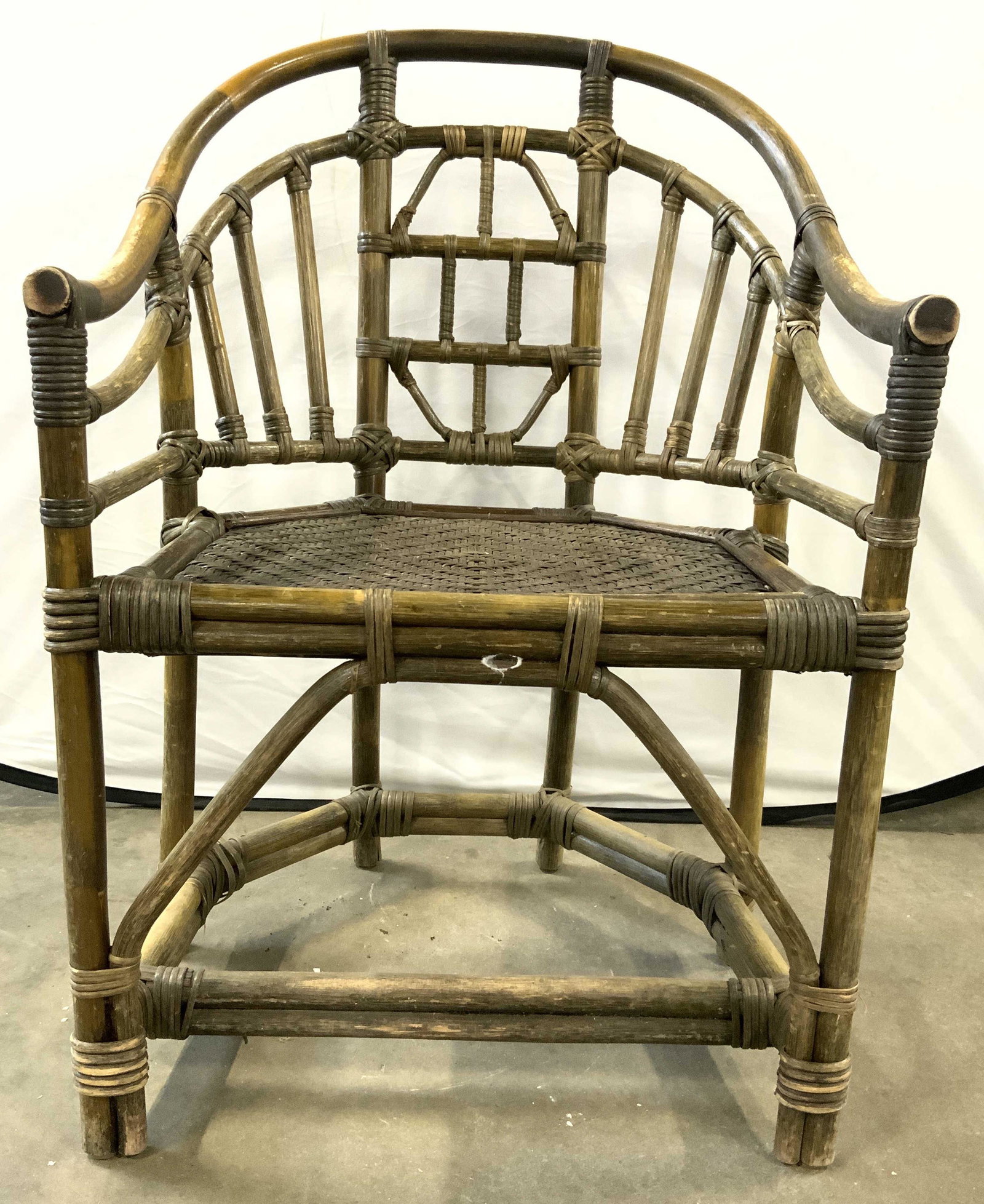 Vintage Bentwood Barrel Back Chair Brown: Chair has barrel shaped backrest & bentwood frame. Piece is brown toned. Chair has wicker seat. Piece has 6 legs with stretcher in between. Chair measures approx 36 inches tall 24 inches wide 22 inche