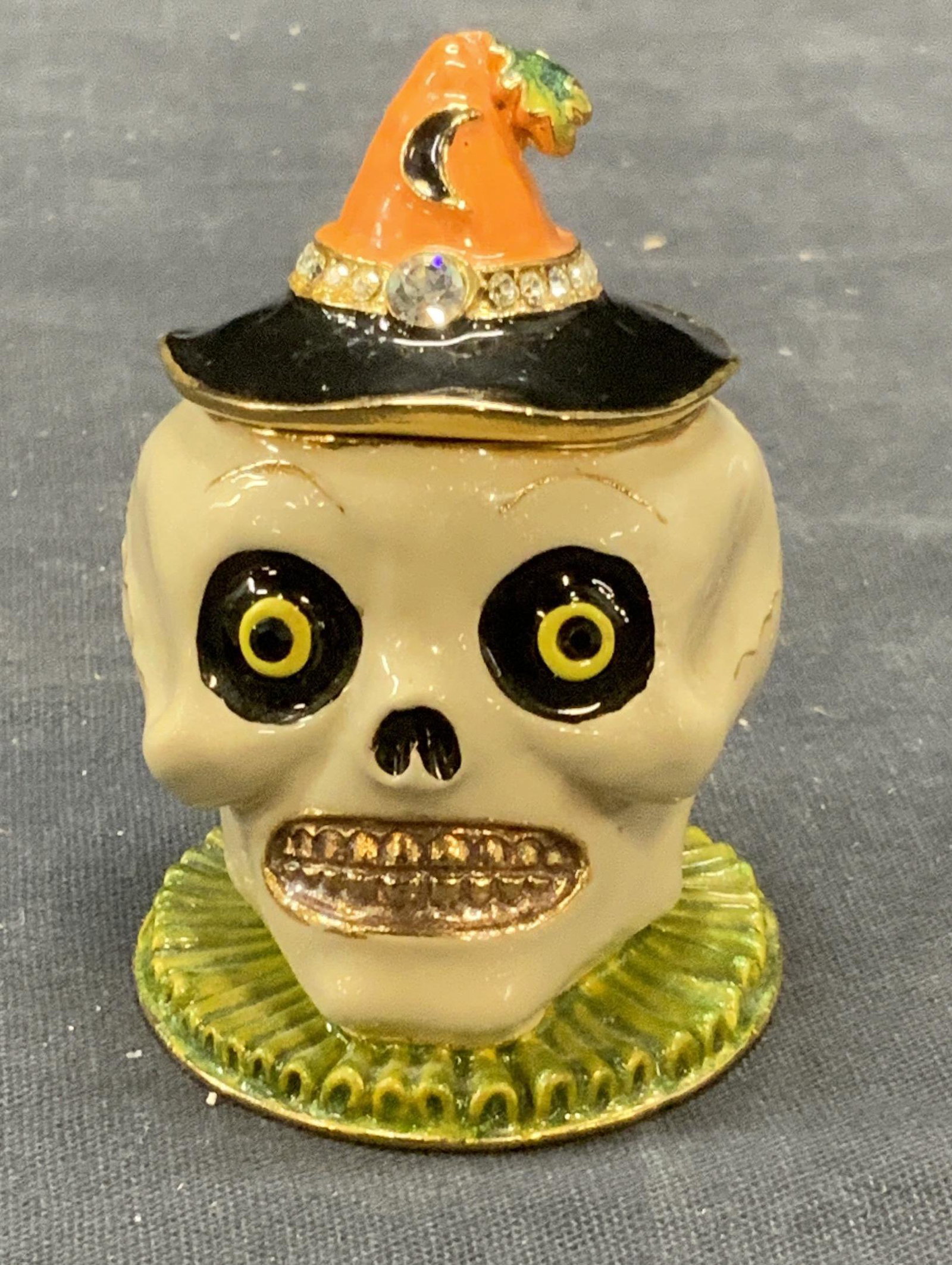 Enameled Halloween Skull Pill Box: Halloween skull pill box with crystal decoration. Enameled Metal. Measures approx. 1.75 inches wide and 2.25 inches tall. In good condition. Enameled pill box, pill box, skull pill box, Halloween pill