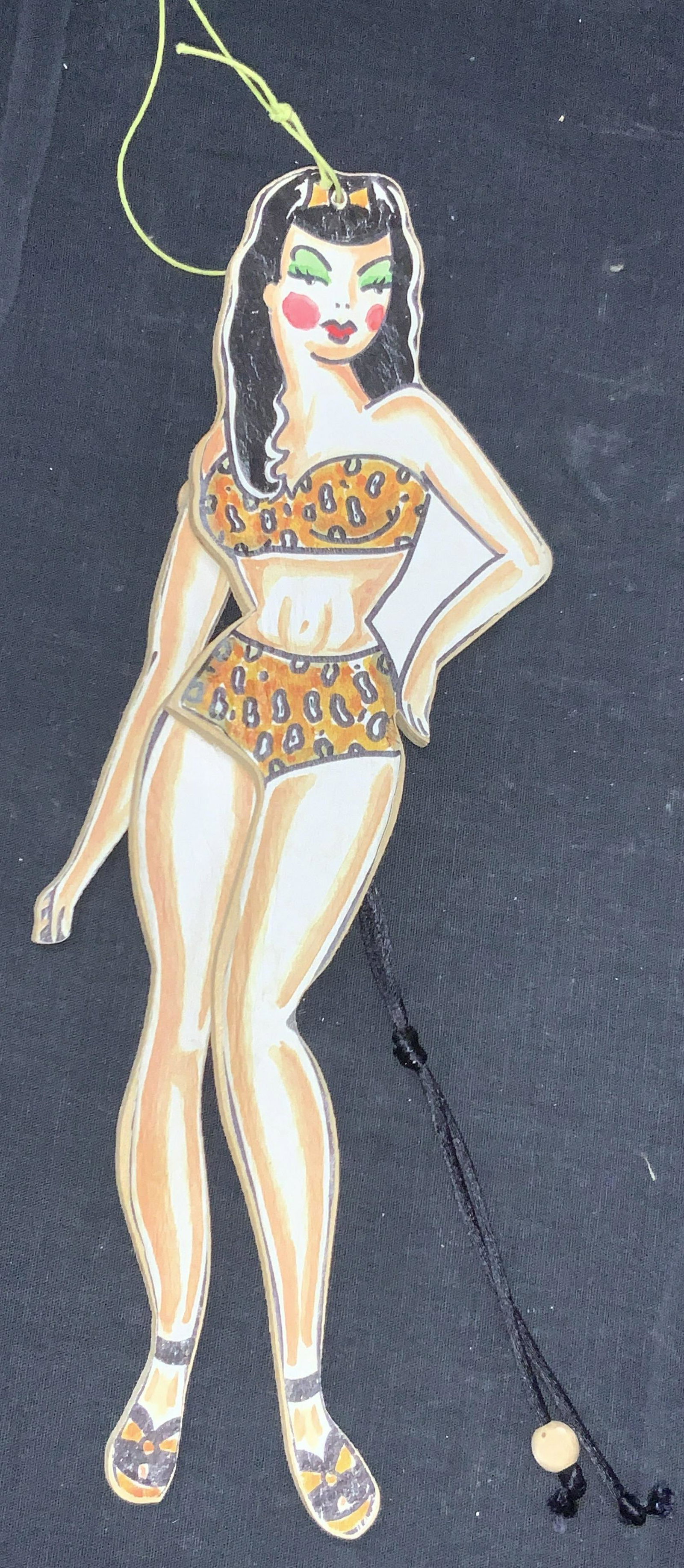 Laughing Moon LLC Wooden PinUp Style Puppet: Marked on backside sticker, Laughing Moon llc. Ventura California, hand made in U.S.A copyright 1996. Wooden man puppet with paper image of a pin up girl in a leopard bikini. Approximately 12 inches l