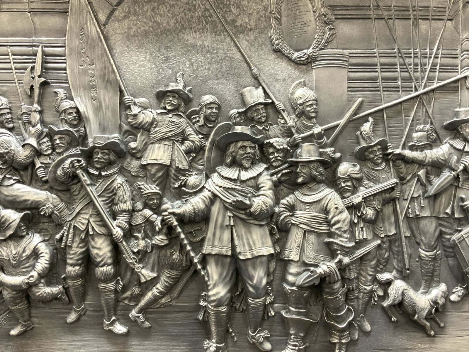 THE NIGHT WATCH Embossed Pewter Plaque: Marked on lower left corner J.A.Weenekes Marked on plaque in wooden frame, Rambrandi Van Rijin 1606-1669 Die Natchwache. Backside is marked W Mf Sinn, ges, Gesch. Embossed prettier depicting a group o