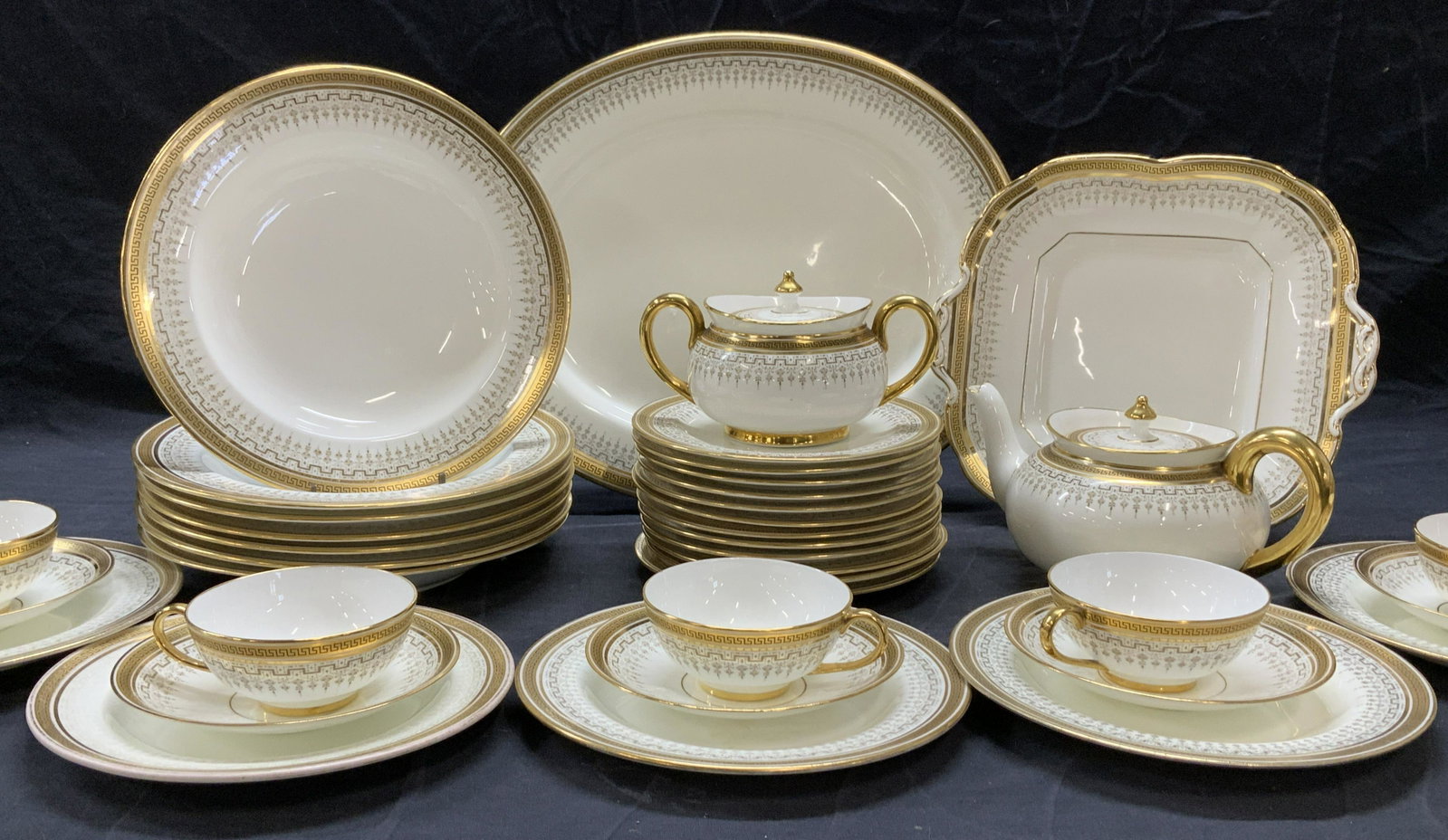 Cauldon Ltd Fine Bone ChinaWare 37, England: Fine bone chinaware, partial set,Hallmarked Cauldon LTD for Burley & Co Chicago. White China with Greek key pattern in gilt and neoclassical design. A few pieces have some surface wear. Partial set in