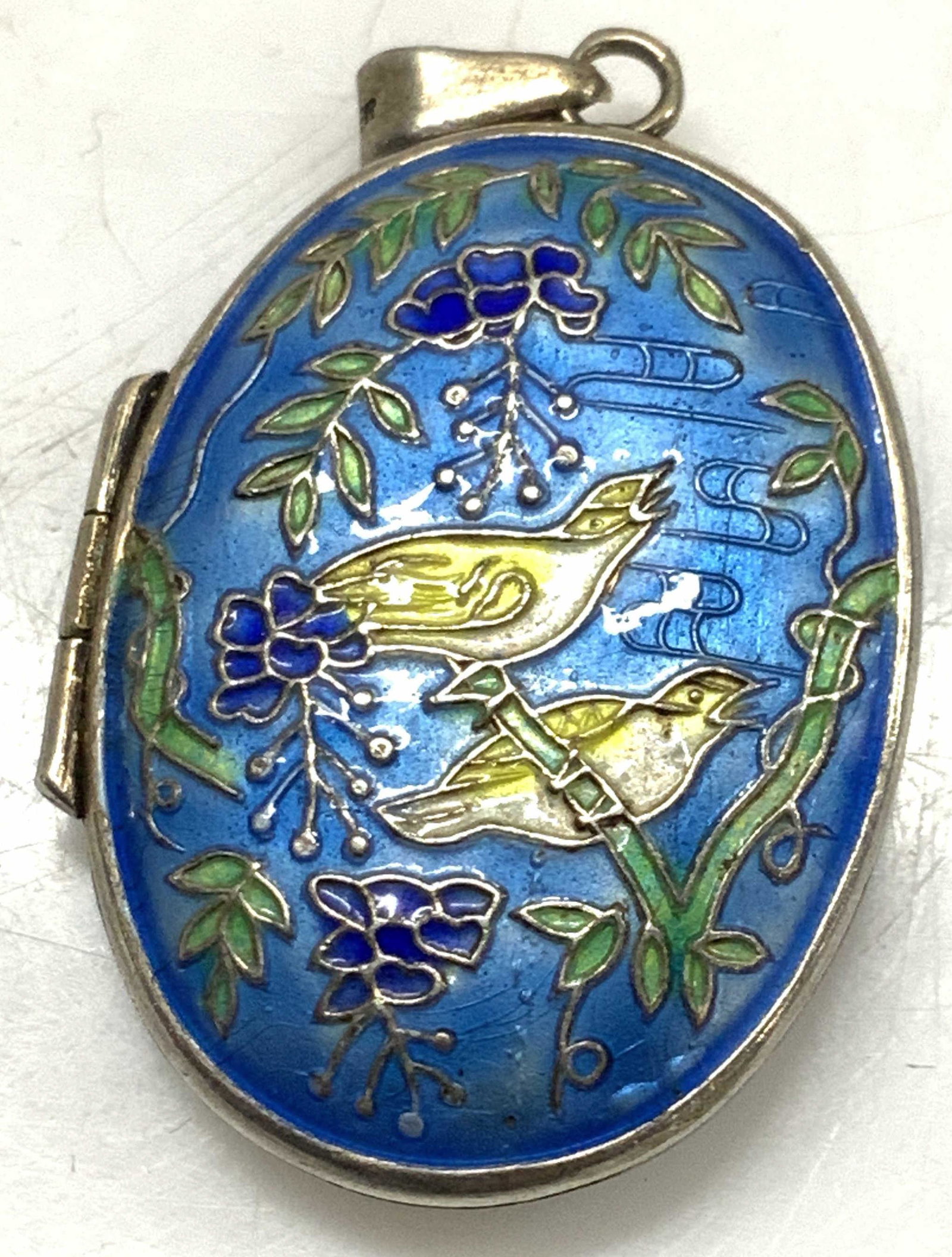 Silver & Enamel Locket Pendant: Enamel locket with blue enamel and silver metal. Birds perched on branch motif. Light blue , yellow, green and cobalt enamel. .28 ozt total weight 1.5 x 7/8 in. Marked silver Asian style jewelry, Pend