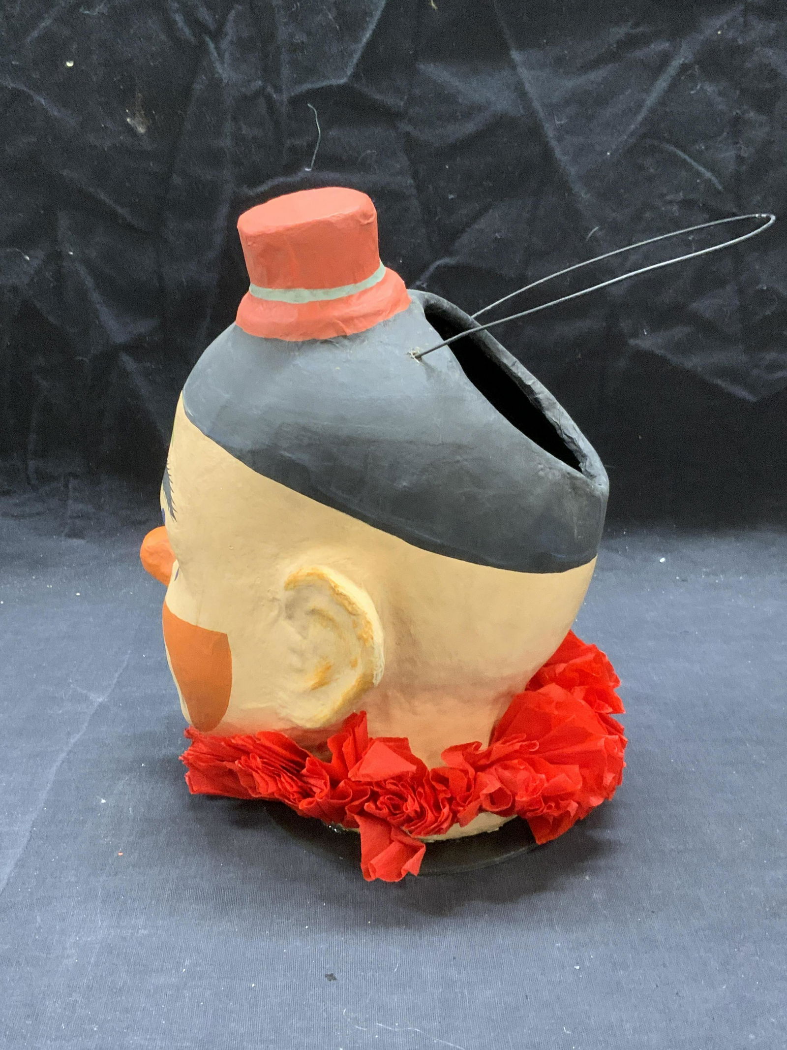 Papier Mache Figural Clown Bucket Philippines: Papier Mache figural clown bucket. Made in the Philippines. Some surface wear consistent with exposure. Measures approx. 6.5 inches wide and 8.75 inches tall. Papier mache bucket, papier mache clown,