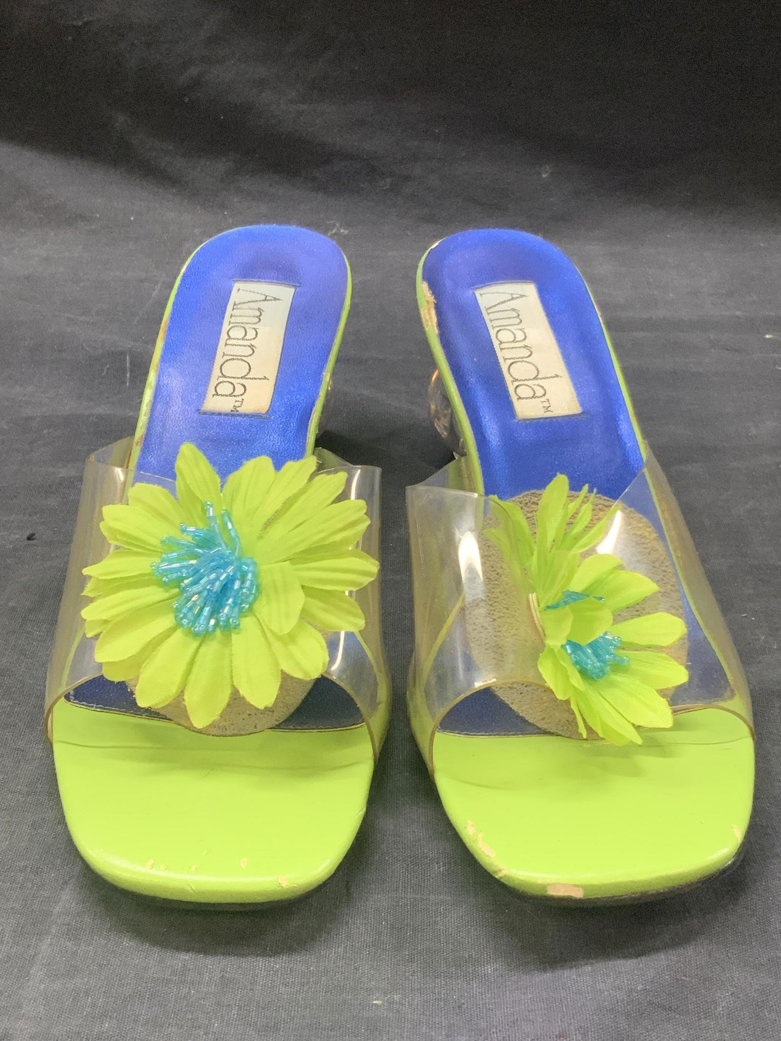 Size 10 AMANDA Clear Orb Heel Sandals: Marked in sole and underside of shoe, Amanda. Size 10, Amanda All Man Made Materials. Clear orb shaped heels with plastic strap and blue green shoe. Approximately 3 inch tall heel. Evident wearing to