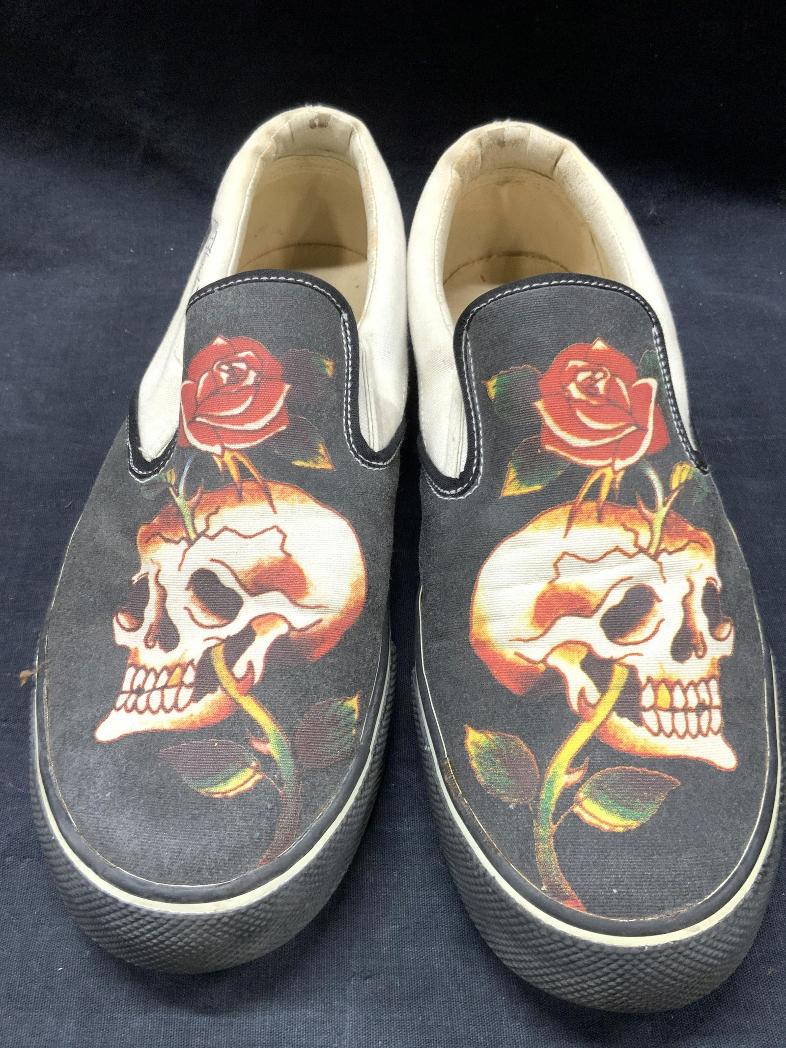 Don Ed Hardy Size 10 Slip On Skull Shoes: Pair of size 10 Don Ed Hardy Slip on shoes with white and blue exterior with skulls on tops. Marked Don Ed Hardy on backside and measurements on interior, Approximately 11 inches long. Evident wearing