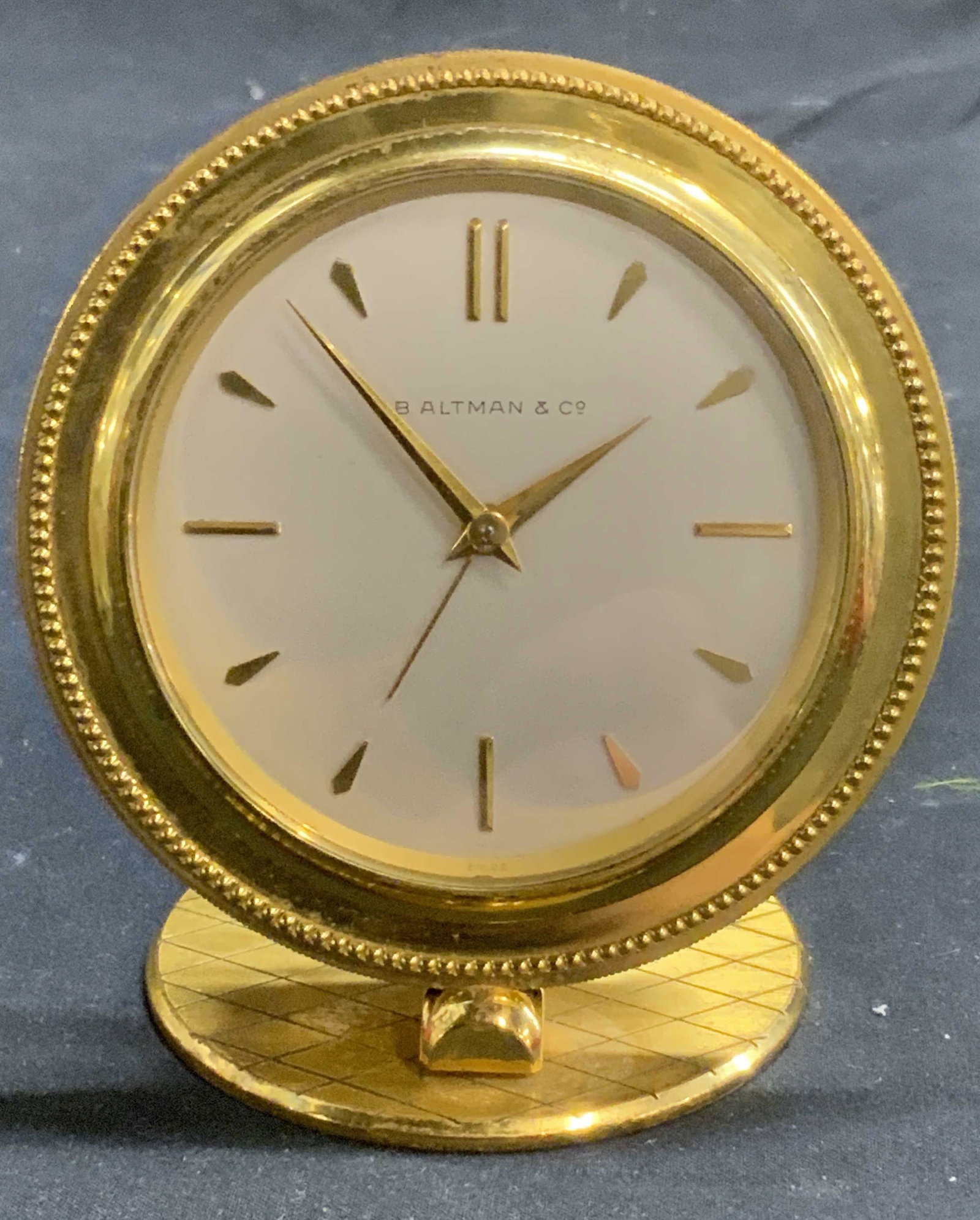 Vintage B ALTMAN Art Deco Gold Tone Alarm Clock: Vintage B Altman Art Deco gold tone alarm clock. Designer label to clock face. Measures approx. 3.5 inches diameter and 4 inches tall. Surface wear consistent with exposure. Not tested for function. B