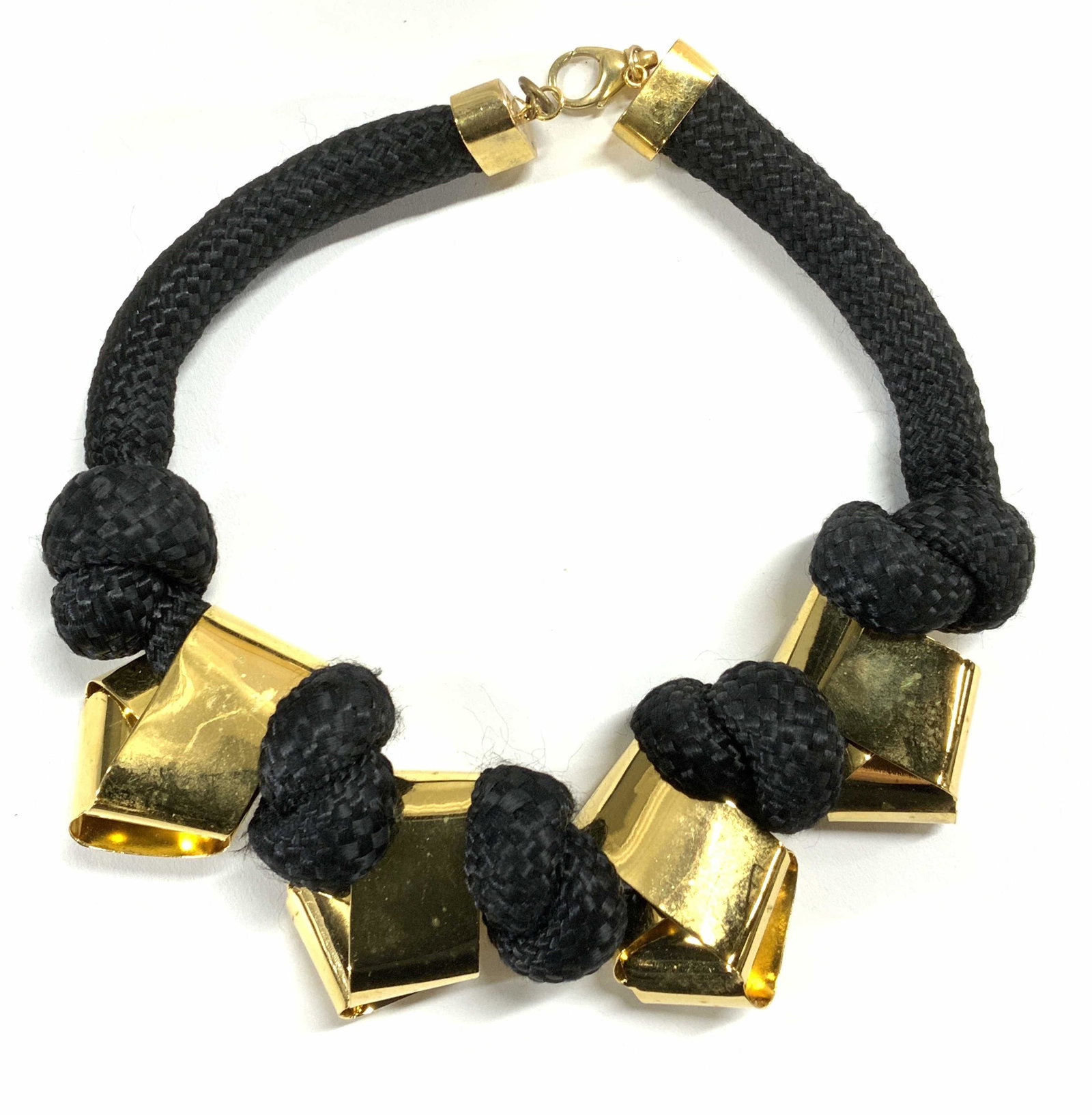 ALEXIS BITTAR Chunky Knotted Gold Tone Necklace: Alexis BITTAR chunky gold tone choker necklace on knotted rope. Lobster claw clasp. Measures approx. 17.5 inches long. Gold tone piece measure approx. 1.75 x 2 inches each. Trademarked to necklace cha