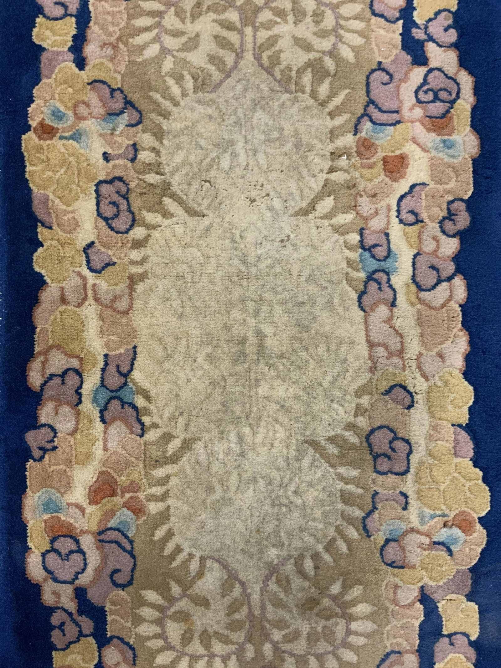 Vintage Chinese Art Deco Wool Rug: Rug is handmade and wool. Piece is vintage possibly antique. Rug has sand toned fringes at edges. Rug has intricate multi toned floral detail measures approx 49 inches long 24 inches wide. Rug, wool r