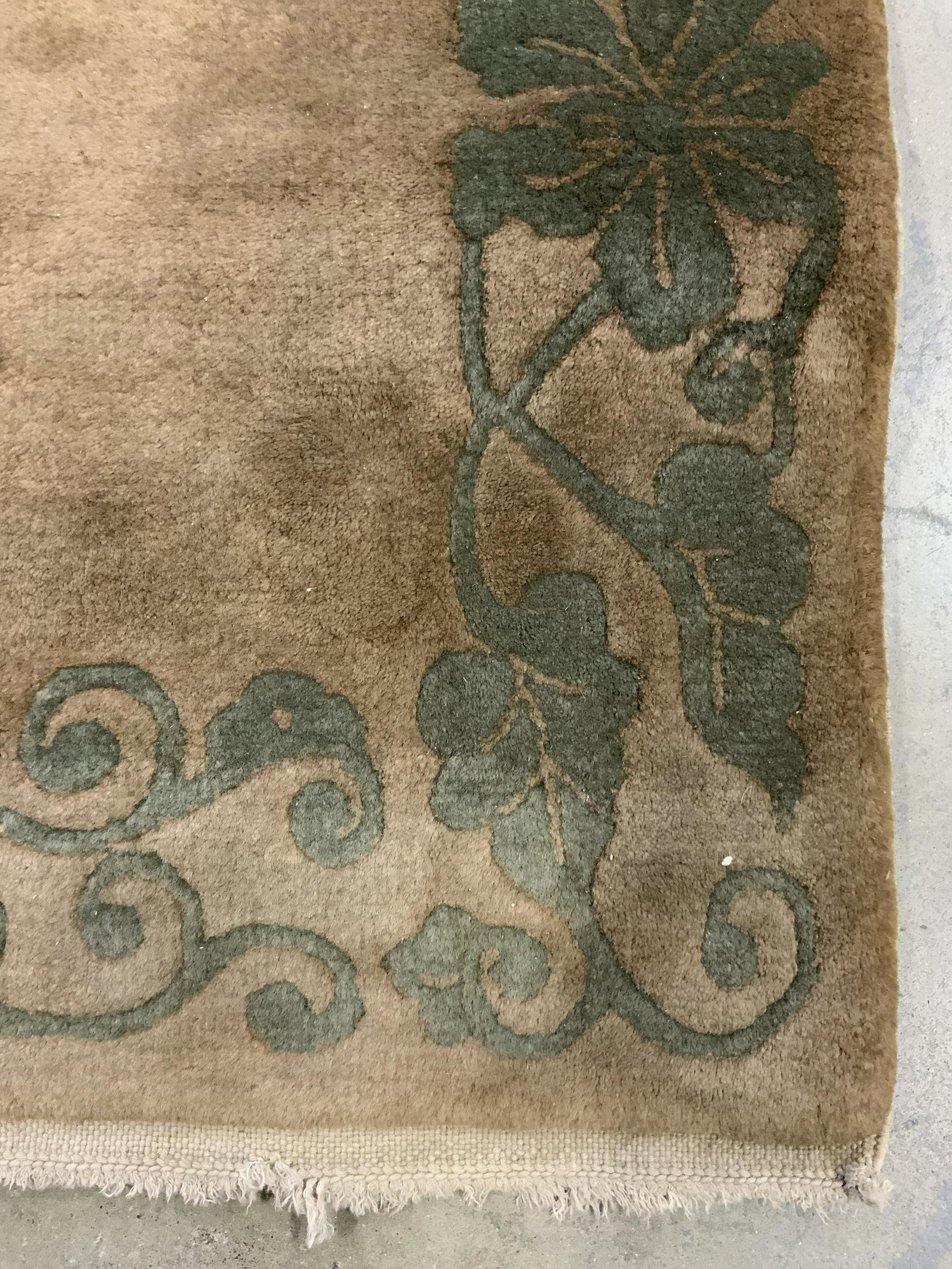 Vintage Chinese Art Deco Wool Rug: Rug is handmade and wool. Piece is vintage possibly antique. Rug has sand toned fringes at edges. Rug has intricate multi toned floral detail measures approx 62 inches long 36 inches wide. Rug, wool r