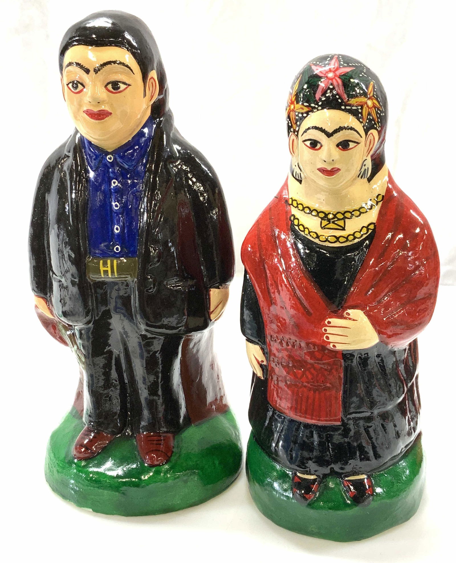 Pair Hand Painted S/P Shakers F Kahlo, D.Rivera: Hand Painted Plaster salt and pepper shakers, Frida Kahlo and Diego Rivera. Both have plastic plug on underside. Diego figural measures 6.5 x 3 x 3 in. Frida figural 6 x 2.75 x 2.75 in. Weighted piece