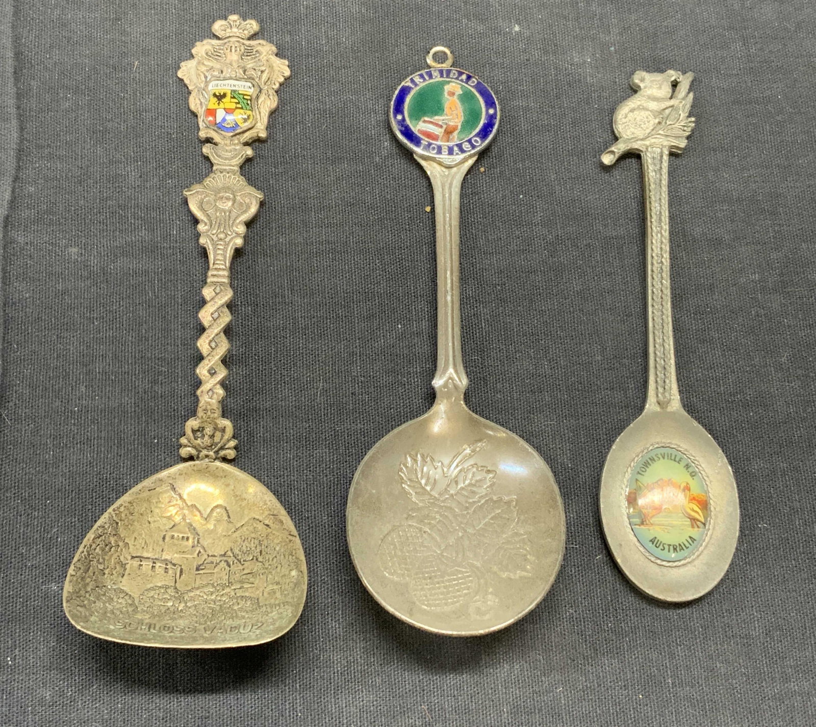 Lot 3 Collectible Vintage Spoons, Travel: Lot of 3 vintage collectible travel ephemera spoons. Includes, Lichtenstein, Trinidad & Tobago, and Australia. Largest spoon measures approx. 5 inches long. All pieces have surface wear consistent wit