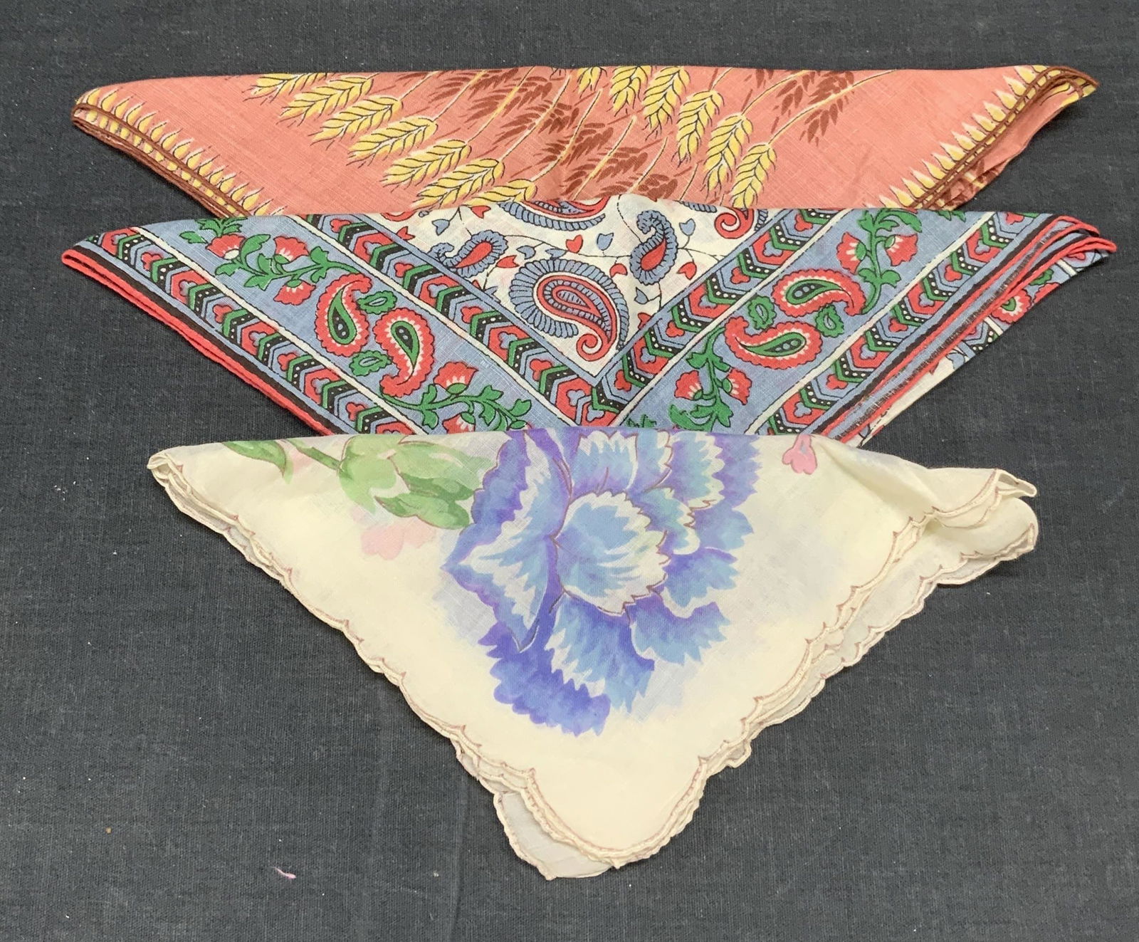 Lot 3 Floral, Paisley, & Wheat Print Handkerchiefs: Lot of 3 handkerchief with graphic prints. Materials feels like cotton. All pieces have some wear to fabric consistent with exposure. Floral print handkerchief measures approx. 12.5 x 12.5 inches. Pai