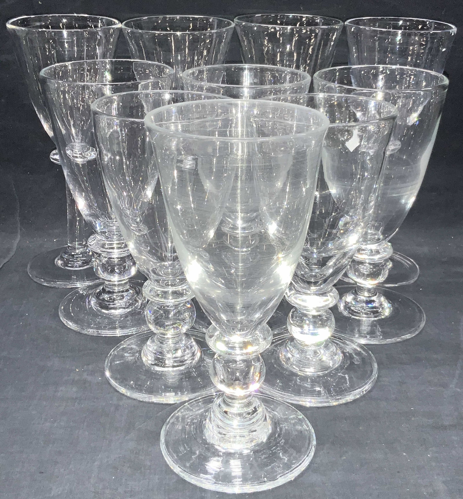 Set 10 SIMON PEARCE Hand Made Crystal Stemware: 10 hand made crystal Simon Pearce stemware glasses. 4 long stemmed wine glasses, approximately 8.75 inches. 7 crystal goblets, ranging in sizes 7.5 to 8 inches tall and 3.75 inch diameter. Each glass 