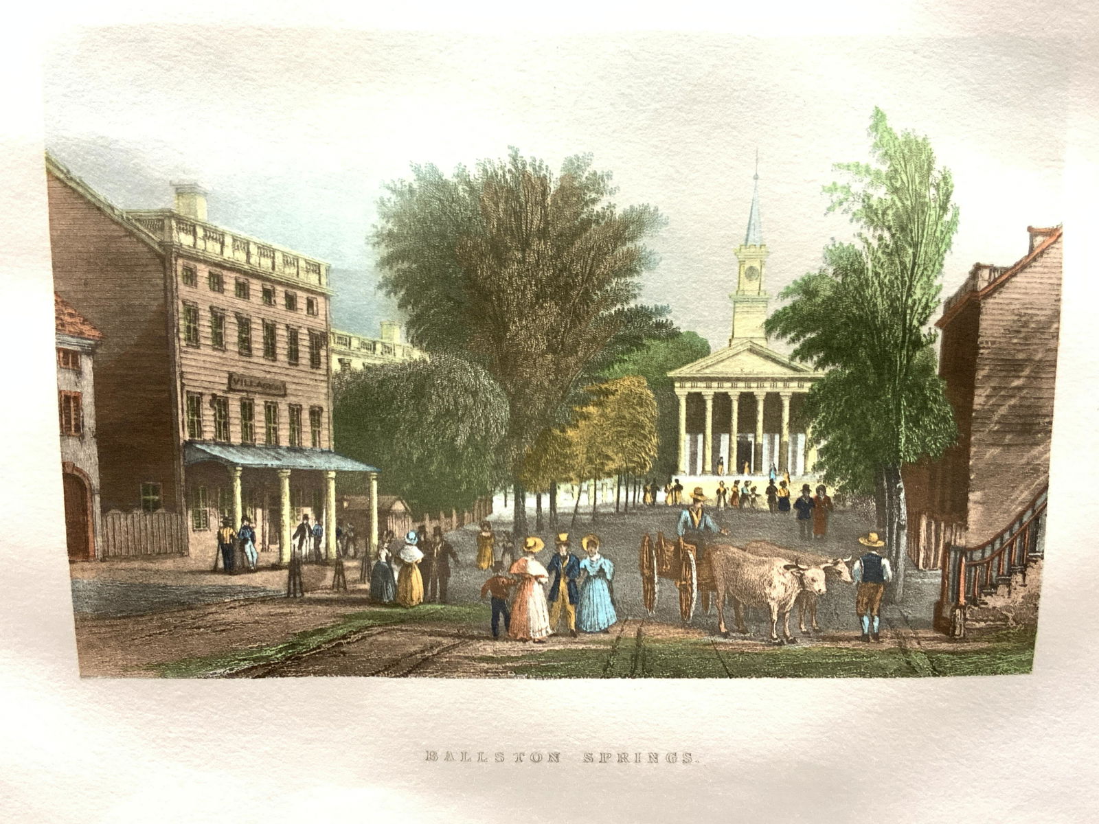 Ballston Springs Colored Etching: Marked on center Ballston Springs Depicts the Ballston Springs town with church in the center of the town and 18th century settlers around. No frame, comes with black mat board. Approximately 12.75 x