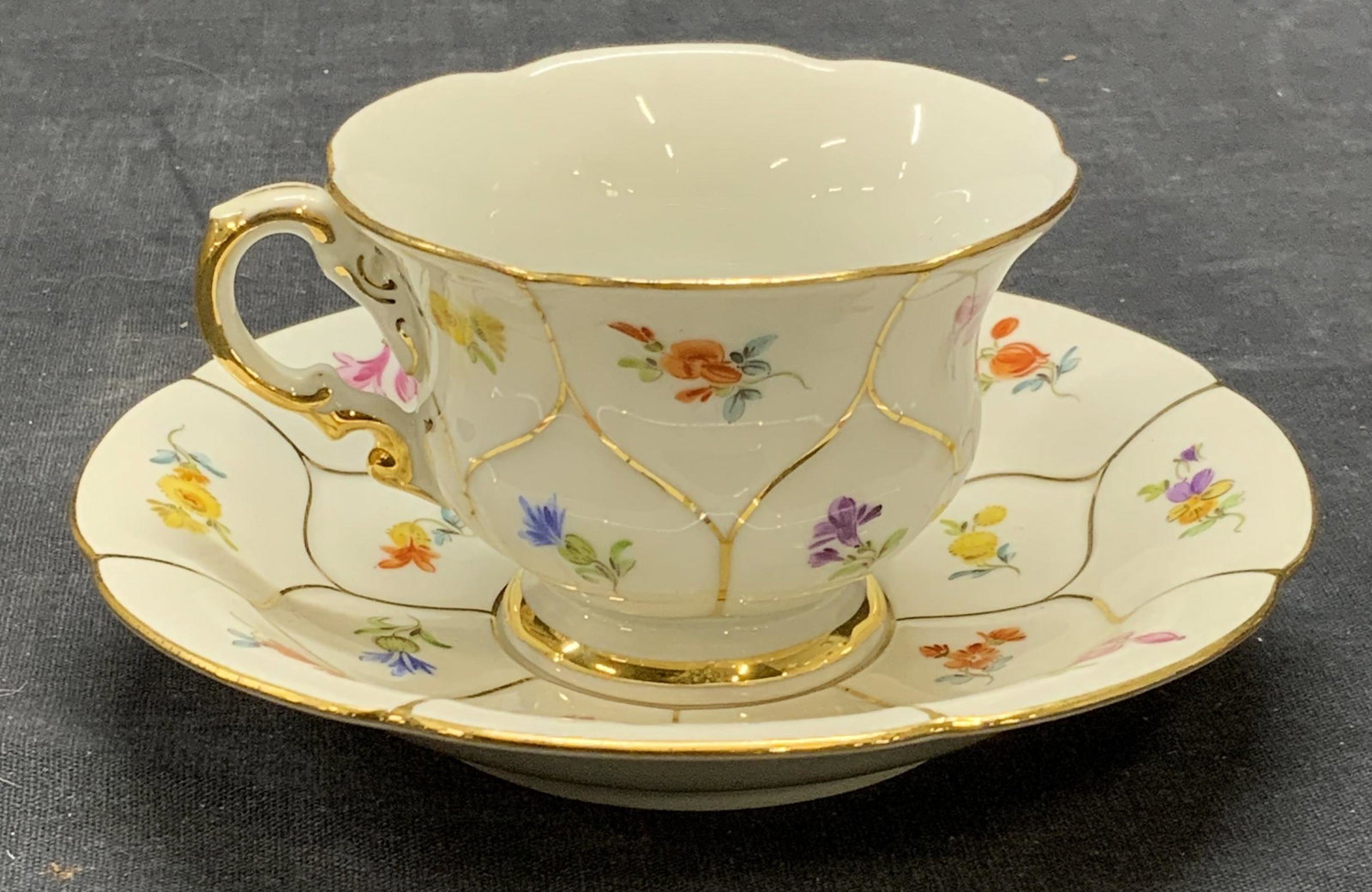 Vintage MEISSEN Porcelain Teacup & Saucer Germany: Vintage Meissen porcelain teacup and saucer with floral motif and gilt decoration. Vintage circa 1930s. Saucer measures approx. 5 inches diameter. Teacup measures approx. 3 inches diameter and 2 inche
