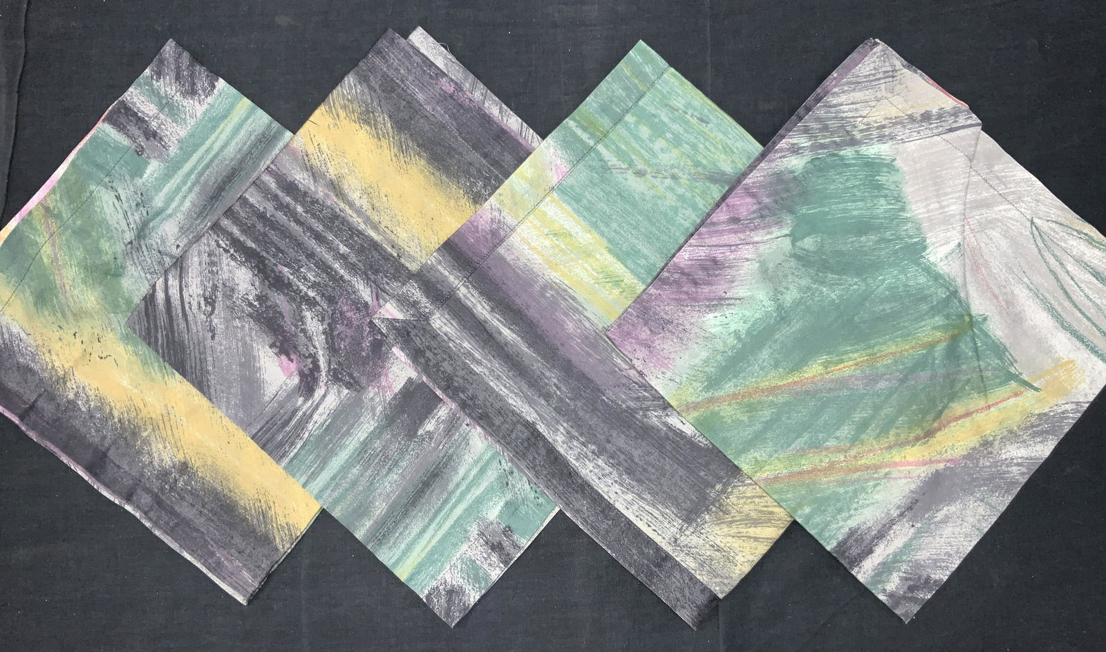 4 Abstract Style Cotton Napkins: Set of 4 fabric Napkins, possibly cotton Adorn in abstract style patterns of paint streaks in tones of blacks, green, yellow and purples. Approximately 18.75 x 20 inches No evident issues or blemishes