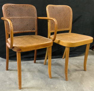 Pair Mid Century Josef Hoffmann Caned Chairs: A pair vintage of mid century Josef Hoffman style bentwood caned chairs. A side chair and an armchair. Slight curve to legs. Armchair measures approx 32H x 15.5D x 19.75W in. Width measured arm to arm