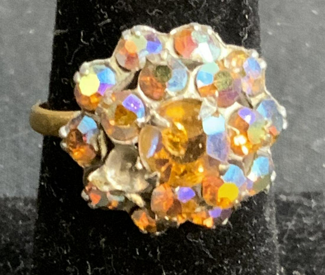 Gold Tone Crystal Cocktail Ring: Gold tone cocktail ring with cluster crystal decoration. Size 7. Cluster measures approx. .5 inches diameter. Surface wear consistent with exposure. Estate jewelry, costume jewelry, cocktail jewelry,