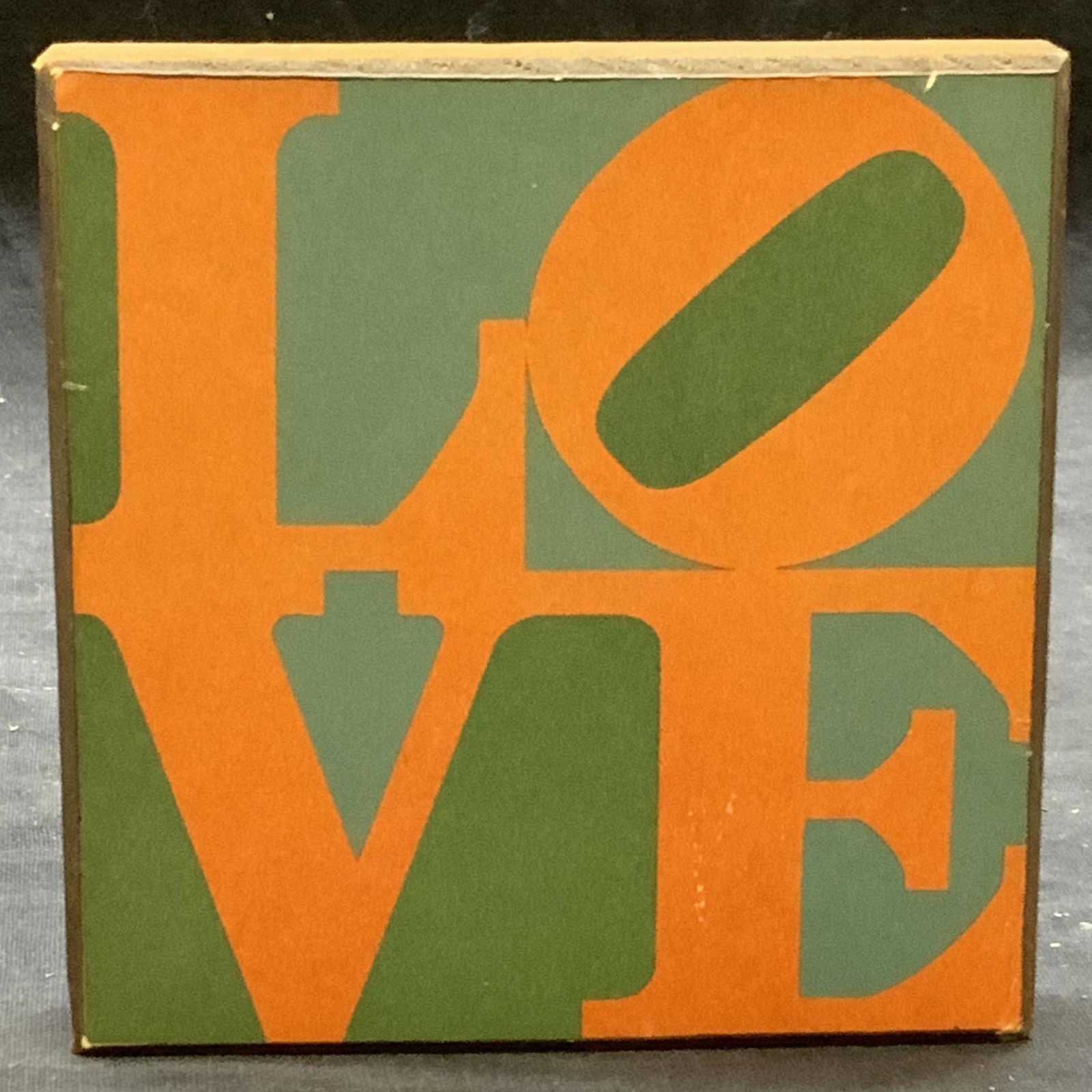 After Robert Indiana Love Wooden Table Decor: After Robert Indiana Love (1965) wooden table decor. Measures approx. 4 3/8 x .75 x 4.5 inches. Some surface wear consistent with exposure. Stamped Robert Indiana, Love, 1965 to underside. Robert Indi