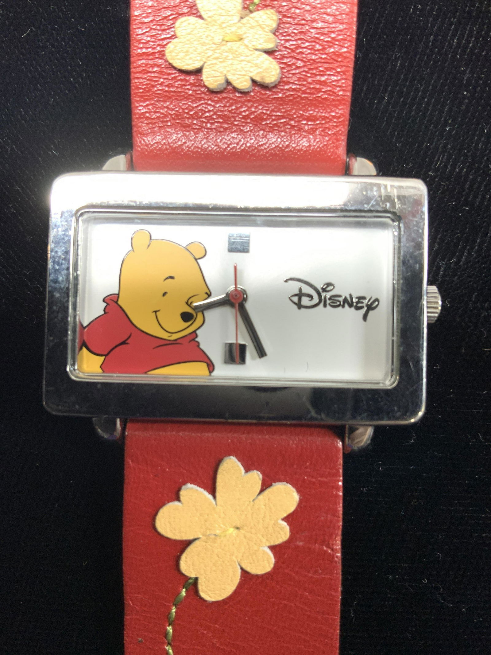 Disney Winnie the Pooh Wristwatch MU 1165: Winnie the Pooh wristwatch with red leather band. 8 in long, band is 3/4 in wide. Signed Disney by SII MU 1165. Japan Movement . Watch case has wear, measures 1.25 x 3/4 in. Not tested for working con