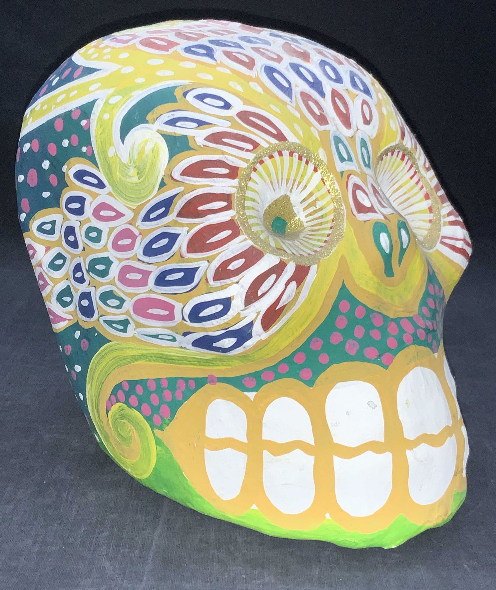 Day Of The Dead Painted Sugar Skull Mexico: Plaster made day of the dead sugar skull, hand painted with vibrant colors and patterns with gold glitter around the eyes, Comes with sticker that reads, made in Mexico. Approximately 8 inches tall an