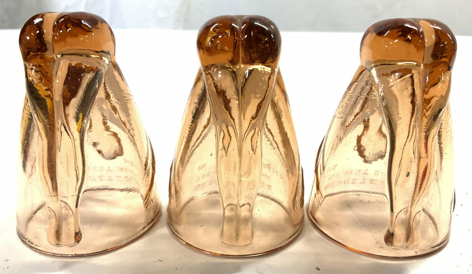 BERRETEAGA Set 3 Bottoms Up Shot Glasses: Lot includes 3 shot glasses, each reads BERRETEAGA THE BEST DRINK IN MEXICO. Each shot glass is peach toned. Each measures approx 3.5 inches tall 2.5 inches wide. BERRETEAGA Shot glasses, shot glasses