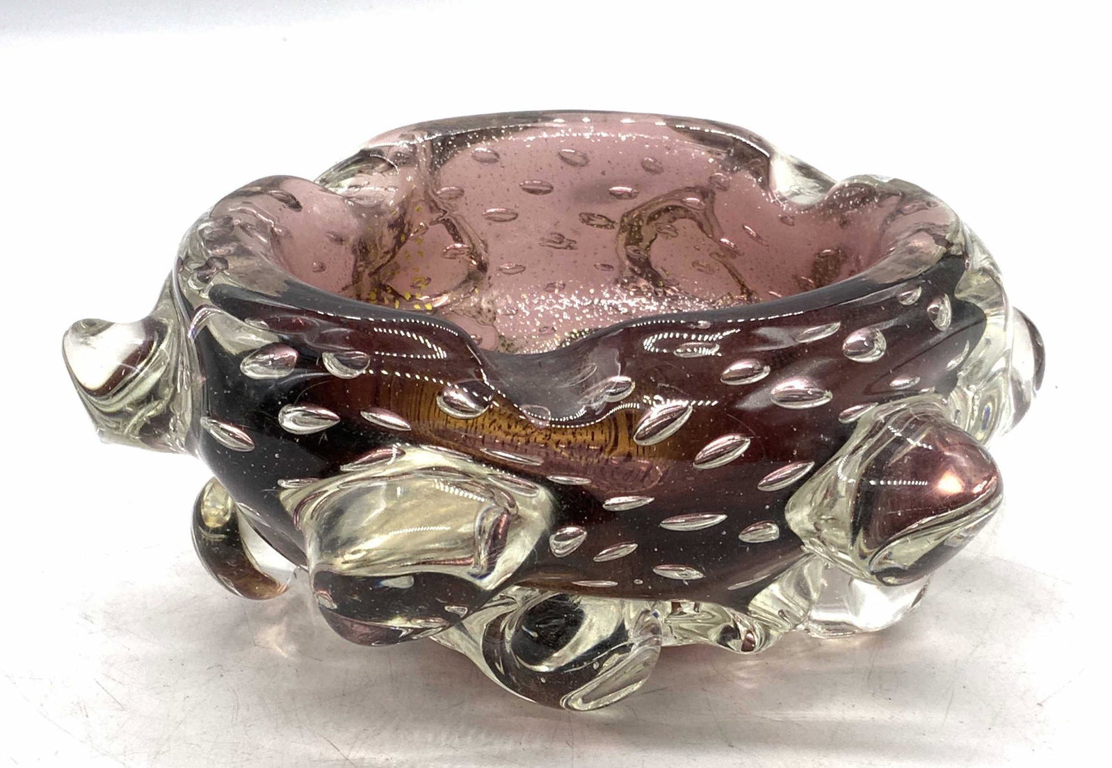Vintage Bubble Art Glass Trinket Dish Bowl: Vintage bubble Art glass ashtray/decorative bowl in hues of purple and gold. Thick walled art glass. Piece is heavy. Some surface wear consistent with exposure. Measures approx. 7 inches wide and 3 in