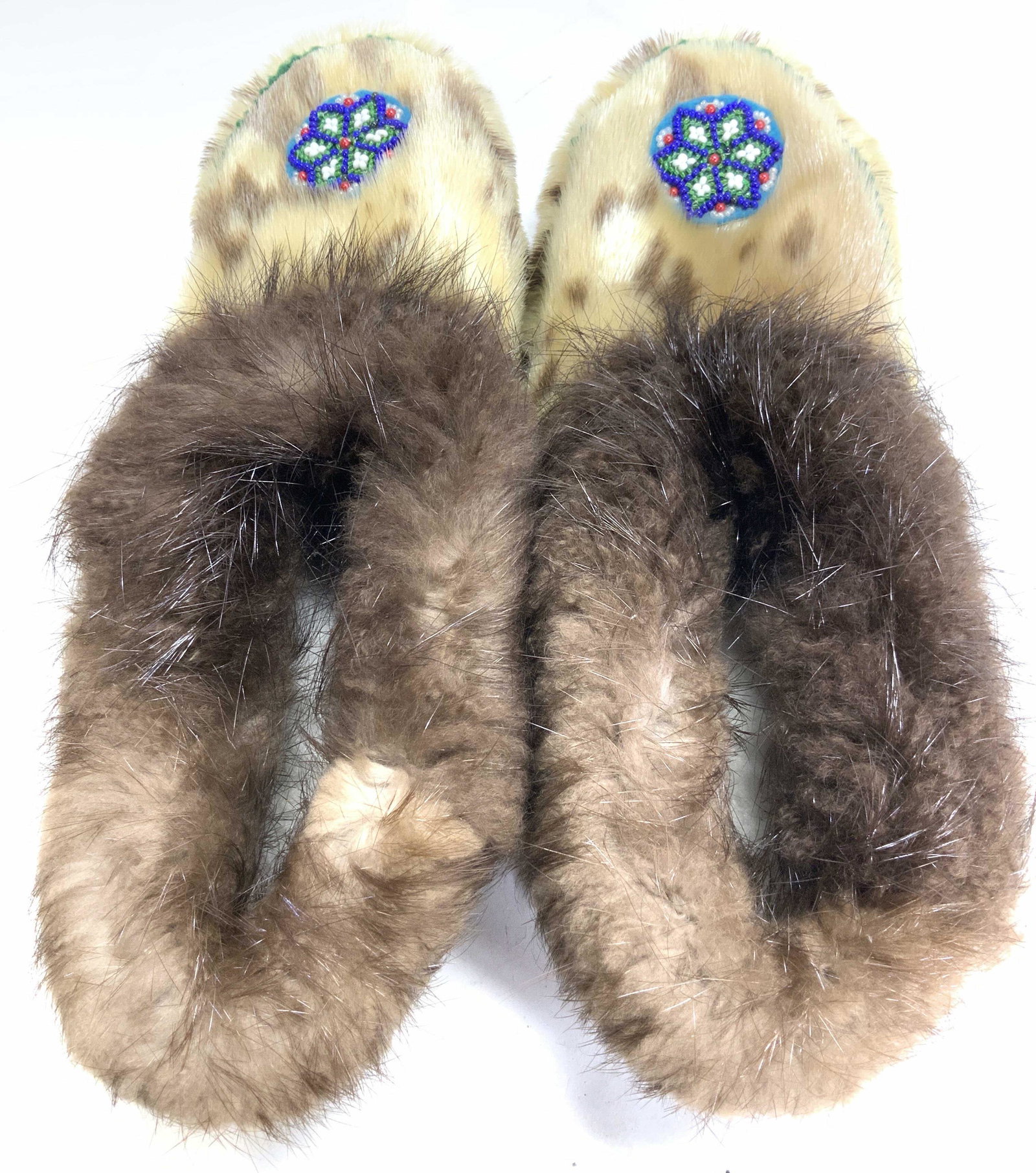 Vintage Fur Shearling Slippers: Natural fur and synthetic fur slippers with hand beaded decor on toe box, suede soles and shearling interior. Slippers measure 1 ft long, toe box 4 in. Wide. Cleaning and inside and outside. Artisanal