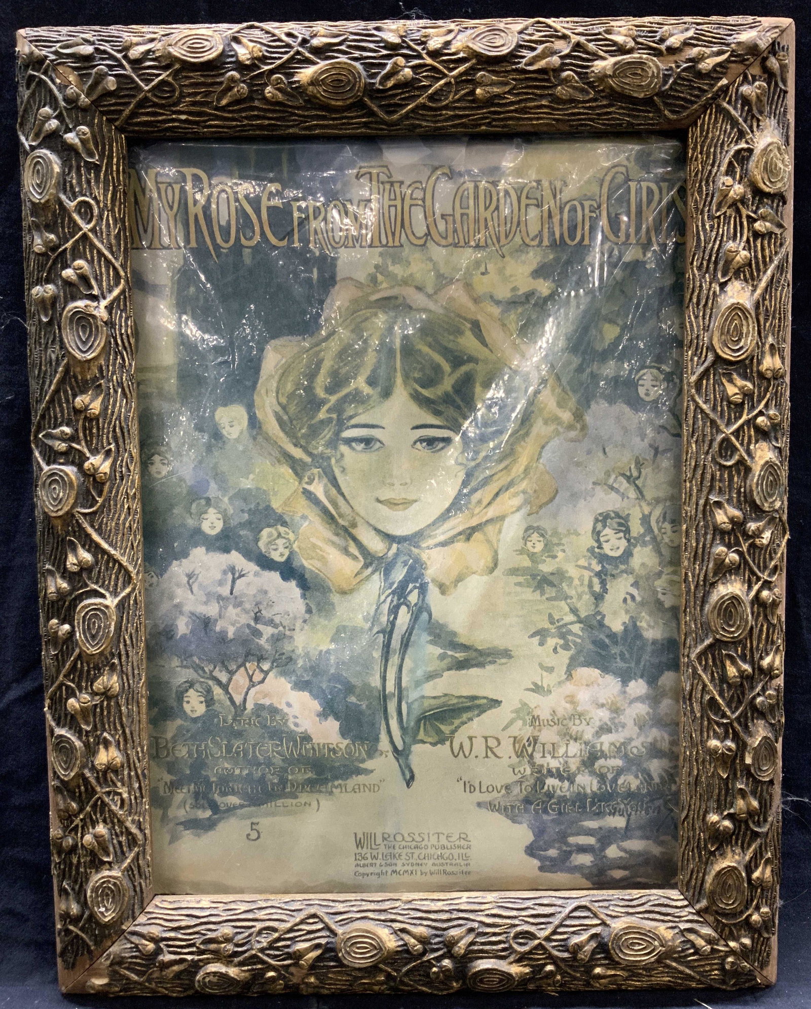 My Rose From The Garden Of Girls Framed Music: Framed sheet music pamphlet, in protective plastic. Depicts a girls head within a rose and various other flowers within a garden also with girls heads. Title Reads My Rose from the Garden of Girls, mu