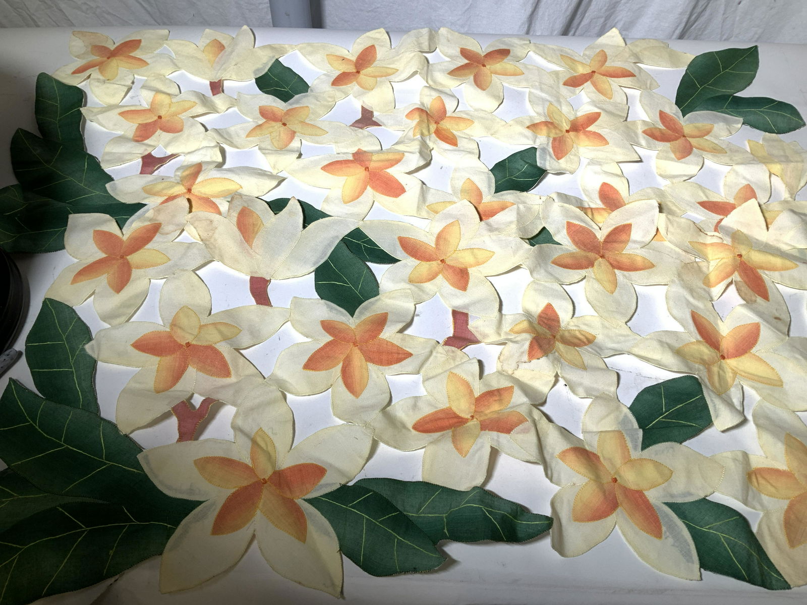 Pair Tropical Flower Linen Table Runners: Bright yellow and Orange flowers with deep green leaves, pierced openwork furniture or table decor, can be used as runners or coffee table centerpiece. Measure 35 x 15.5 in. Blemishing in spots consis