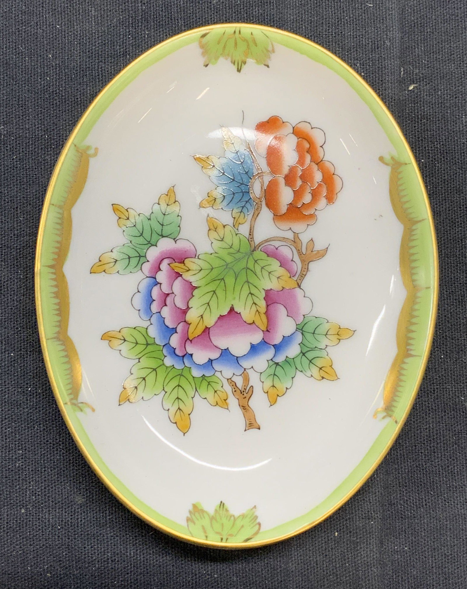 HEREND Porcelain Queen Victoria Trinket Dish: Herend Hungary hand painted porcelain trinket dish in Queen Victoria floral pattern. Trademarked to underside. Measures approx. 3.75 x 2 7/8 inches. In good condition. Herend, herend trinket dish, Que