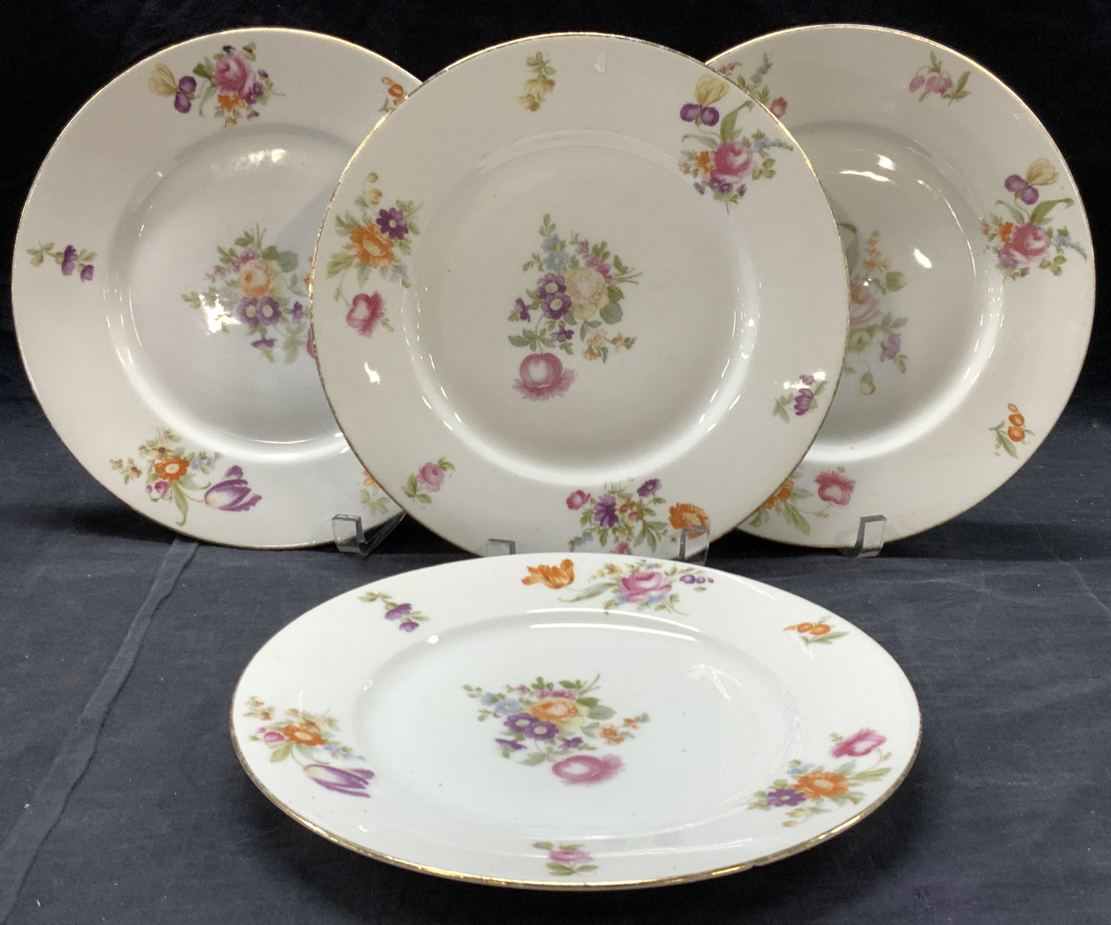 4 Bavaria Else Floral Porcelain Dishes: Set of Bavarian porcelain dishes with Else pattern. Centers and exterior rims of plates are adorn with decals of vibrant colored flowers and silver gilt on rims. Approximately 10 inch diameter. Eviden