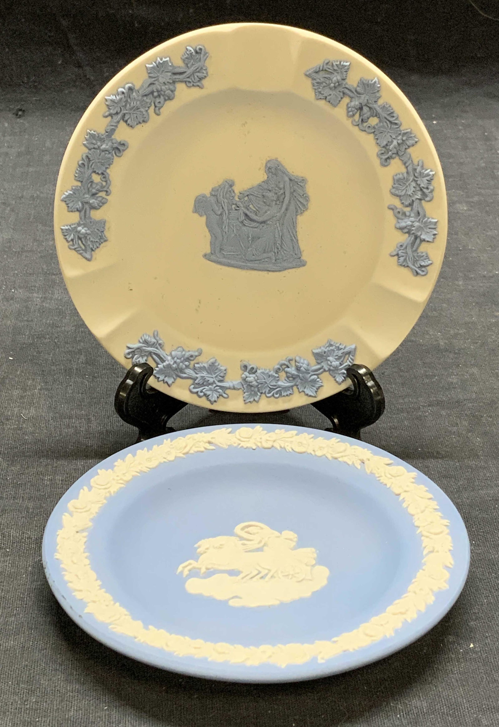 Pair WEDGWOOD Jasperware Trinket Dishes: Pair of Wedgwood Jasperware trinket dishes in blue and white with Grecian figural motifs. Measures approx. 4 3/8 inches diameter. Both pieces trademarked to undersides. Made in England. Some surface w