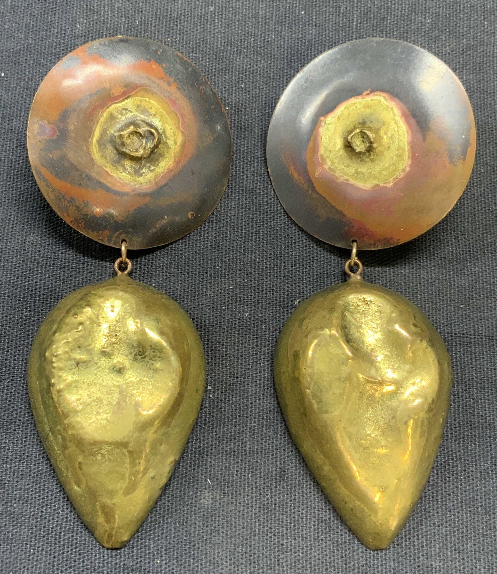Sculptural Brass Dangle Statement Earrings: Sculptural brass statement earrings with round disc studs and drop pendants. Clip on backings. Measures approx. 3.25 x 1 3/8 inches. Some surface wear consistent with exposure. Estate jewelry, costume