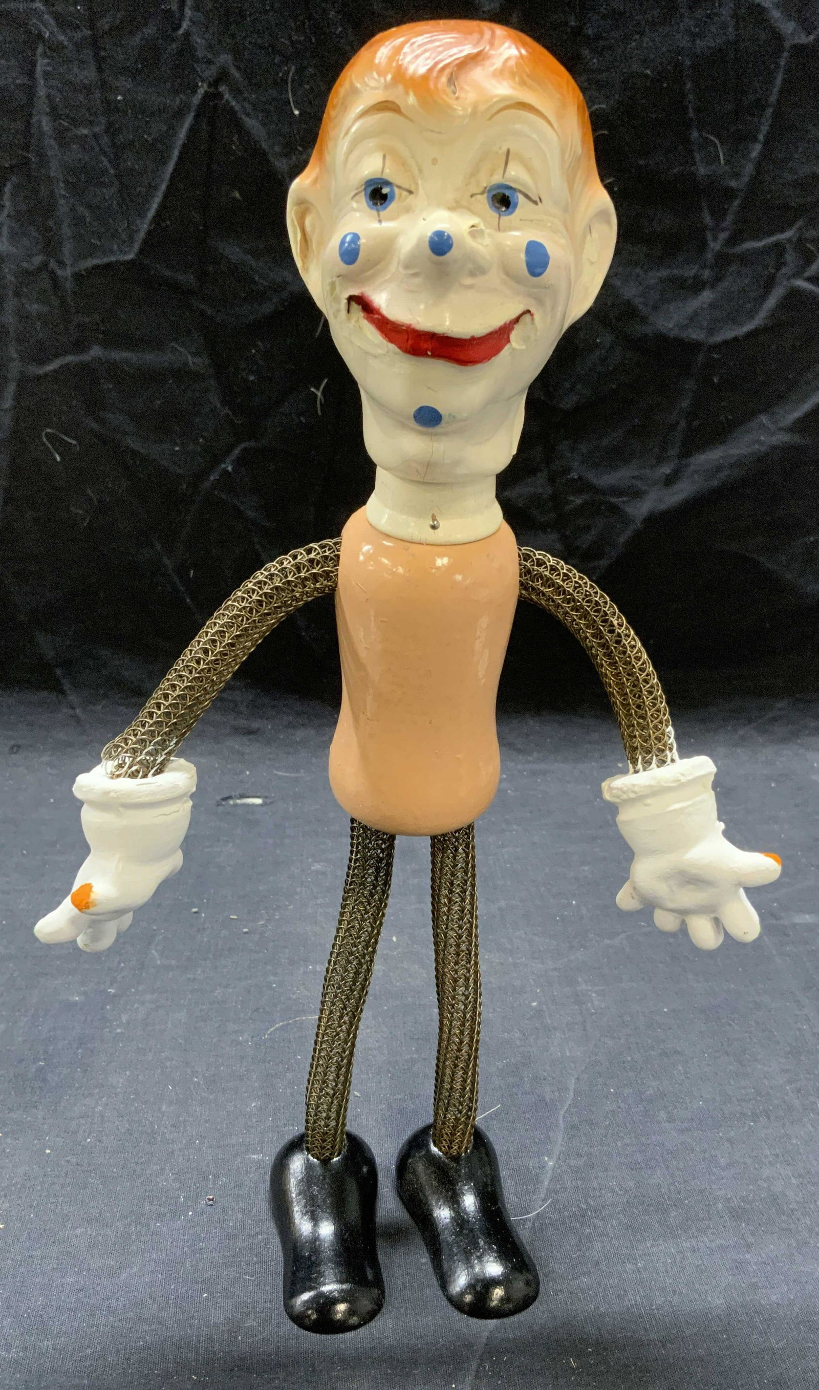 Vintage Hand Painted Wire Clown Figural: Vintage hand painted clown figural. Composed of wire and wood. Arms and legs, and head are posable. Measures approx. 12.5 inches tall and 10.5 inches wide. Some surface wear consistent with exposure. 