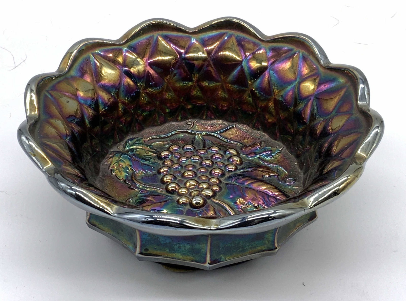 Vintage FENTON Carnival Art Glass Bowl: Vintage Fenton carnival art glass bowl with scalloped rim and grapevine motif. Trademarked to underside. Some surface wear consistent with exposure. Measures approx. 6 inches wide and 2.25 inches tall