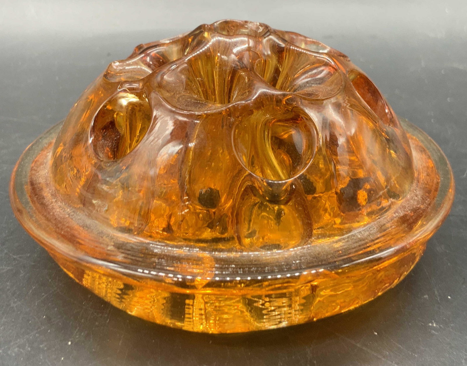 Vintage Amber Glass Flower Frog: A vintage amber glass flower frog / flower organizer. Measures approx 2.25H x 4W in. Some surface wear consistent age and use. Some residue present, some chipping. Collectibles, flower frog, vintage f
