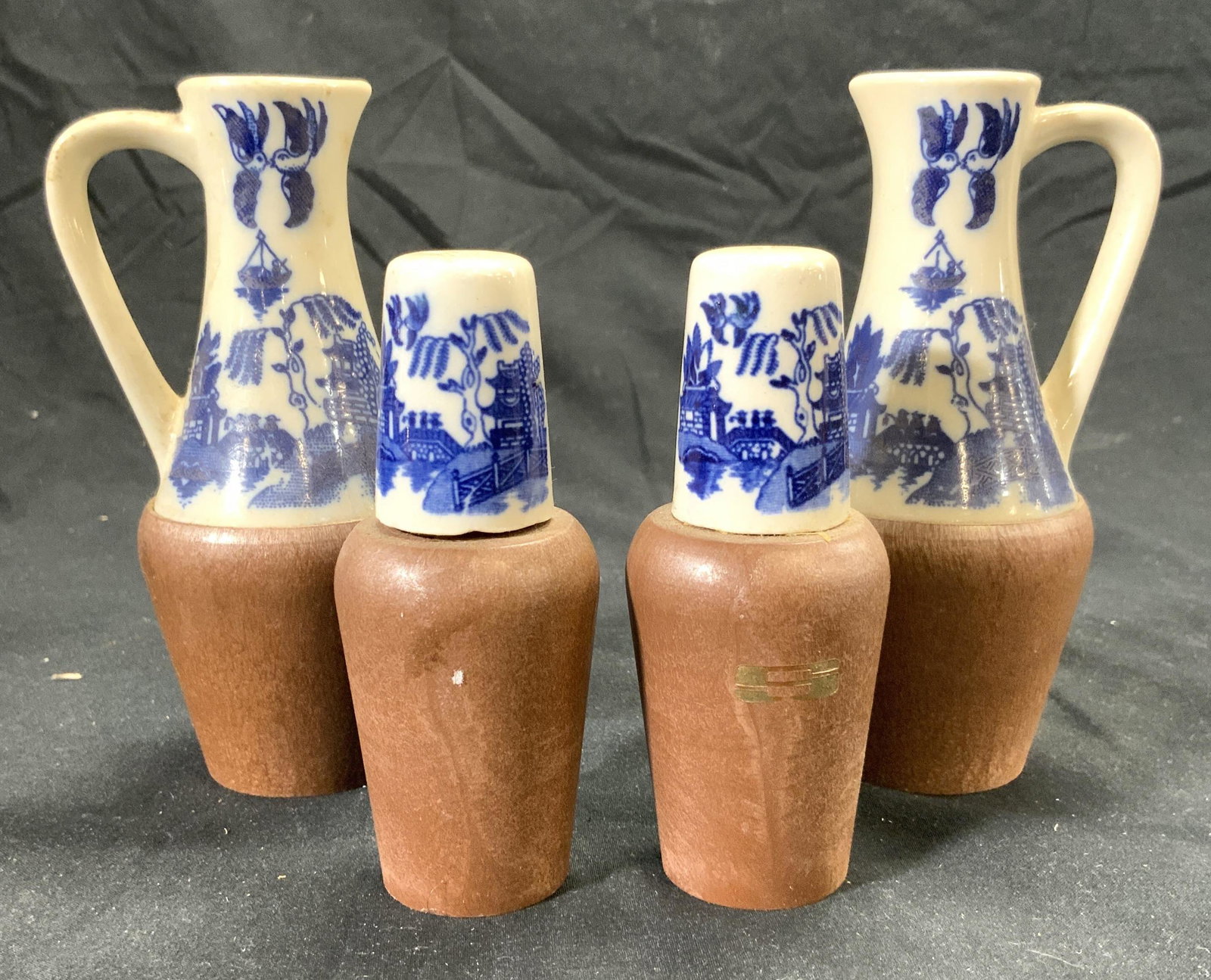 Set4 Vtg Porc Salt Pepper Shakers Oil & Vinegar: Lot includes 1 salt shaker, 1 pepper shaker, 1 oil, & 1 vinegar bottle. Each piece has porcelain tops & brown toned bases which appear to be wooden. Oil & vinegar bottles measure approx 5 inches tall 