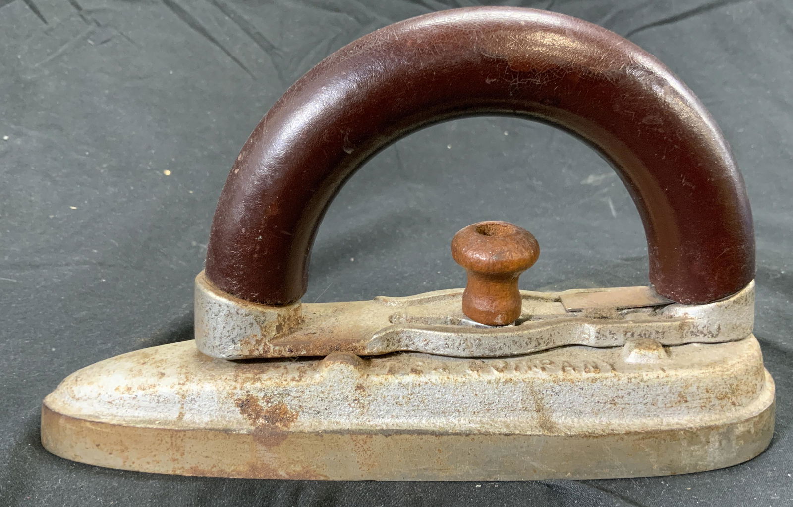 Antique GRAND UNION TEA COMPANY IRON W WOOD HANDLE: Iron reads GRAND UNION TEA COMPANY. Iron is vintage possibly antique. Piece has brown toned arched handle which appears to be wooden. Iron measures approx 8 inches deep 4.5 inches tall 2.5 inches wide