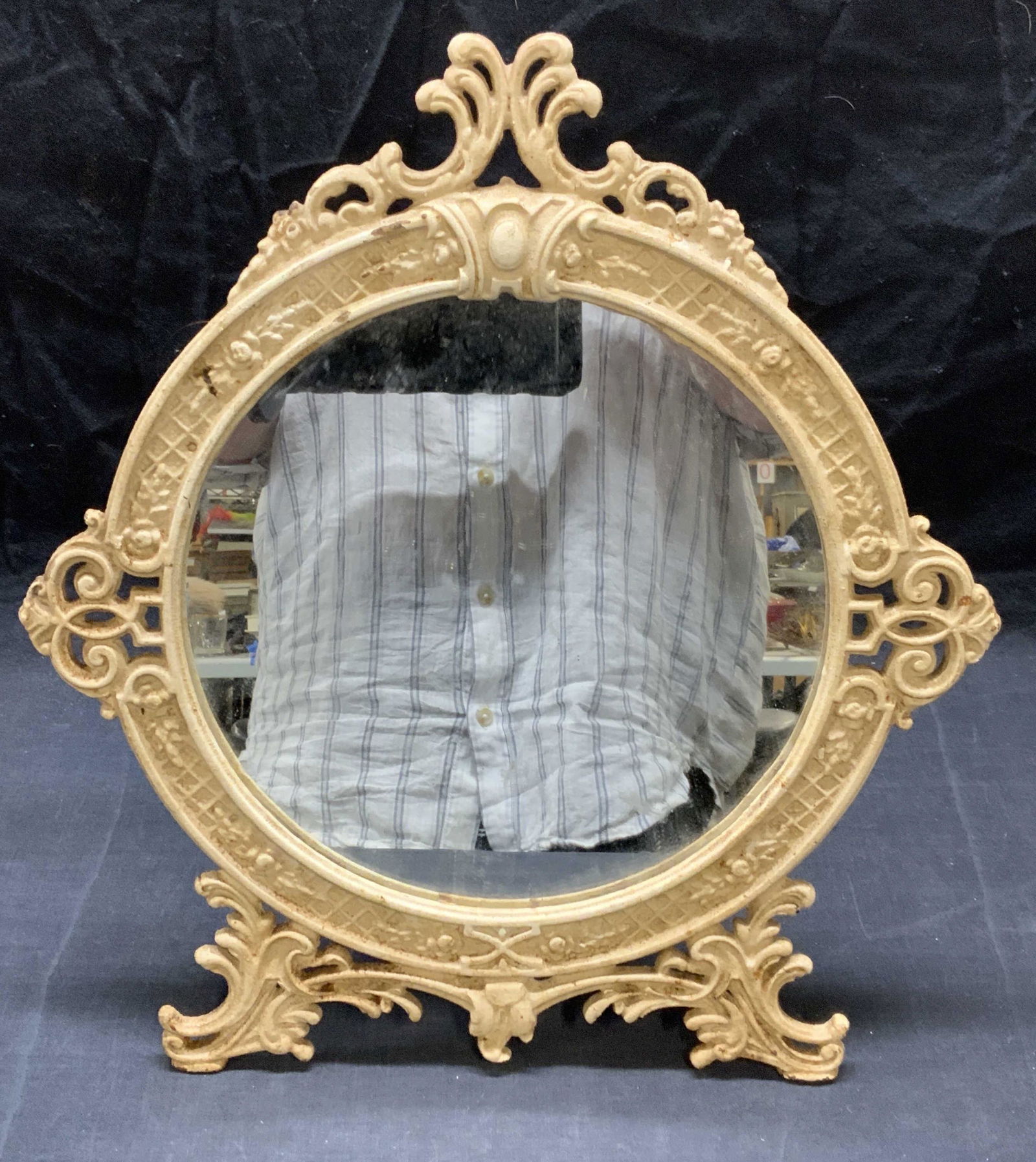 Antique White Iron Table Mirror: Antique white iron table mirror. Wear to surface consistent with exposure, chip to mirror observed. Measures approx. 15 x 13.5 inches. Piece is heavy. Mirror, antique mirror, iron mirror, white mirror