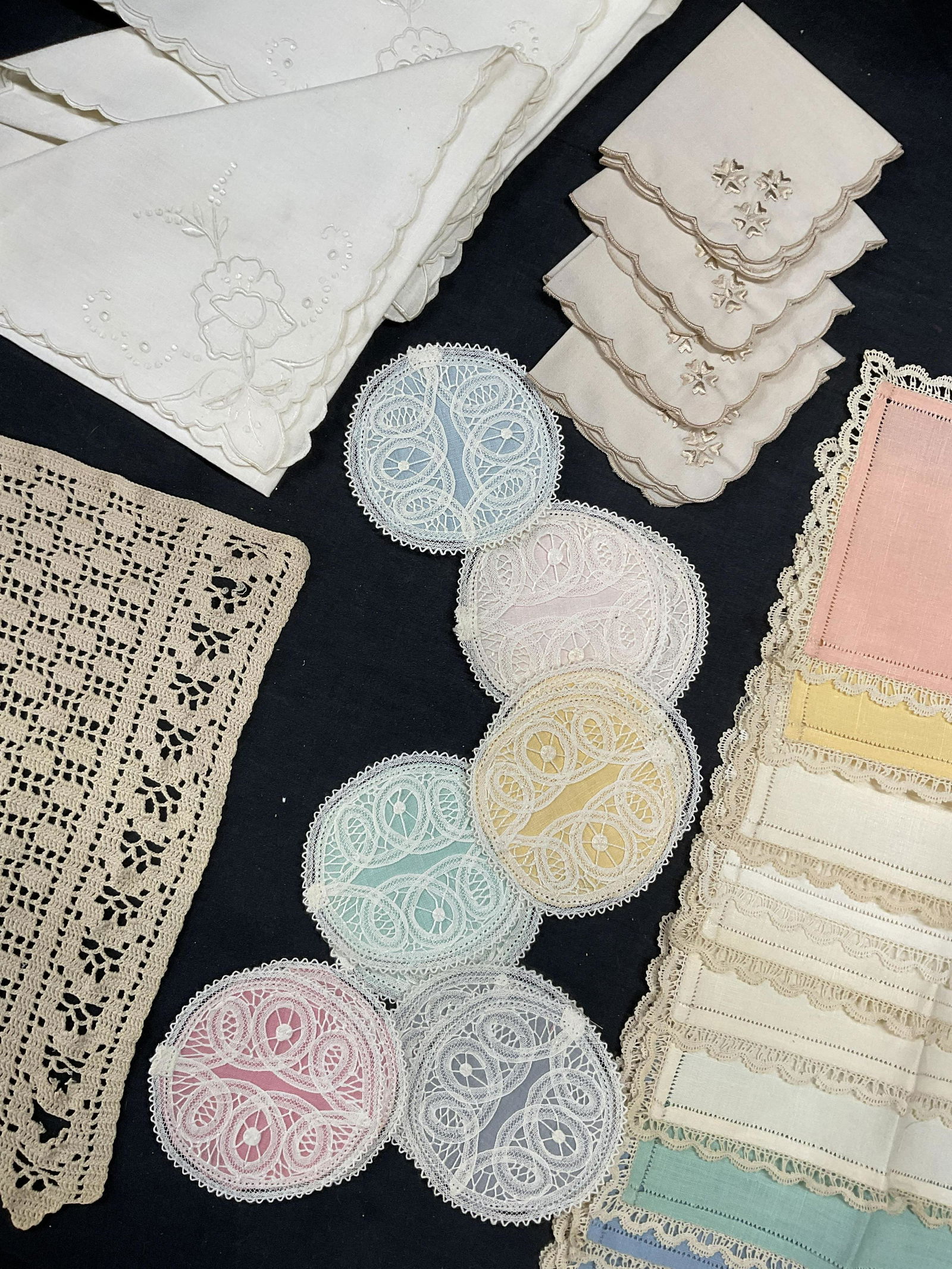 Lot 32 Fabric Lace Tabletop Decor: 32 Fabric Lace Tabletop Decor. Multicolored lace tabletop fabric decor. Largest piece measures approx 18.5 x 17.5 inches. Minor stains to fabrics consistent throughout on some pieces. Some minor tears