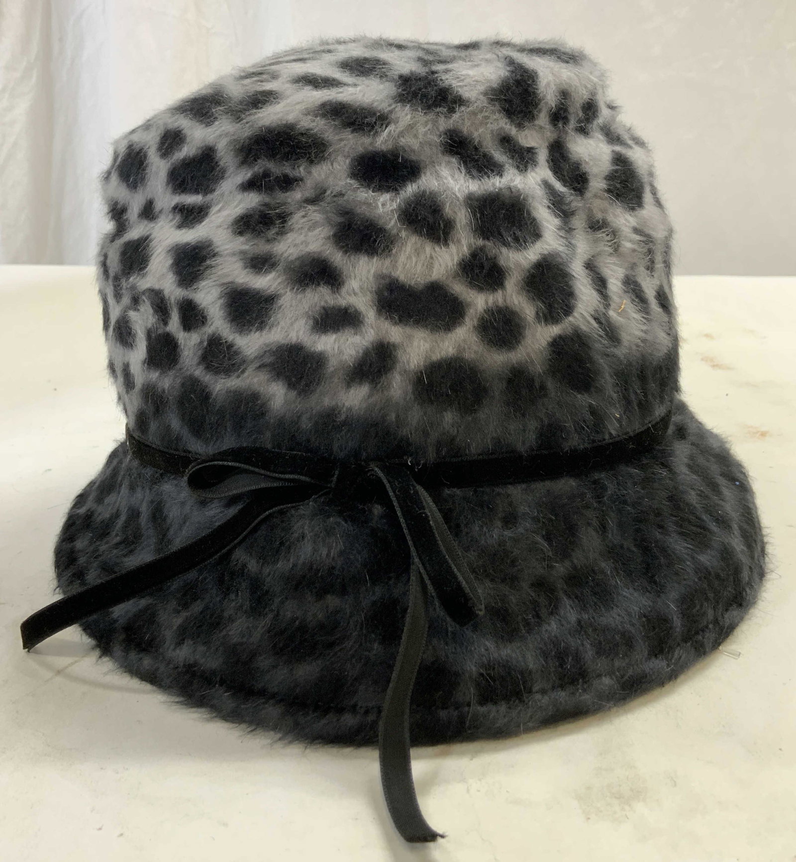 SHERELS Leopard Print Polyester Hat: Hat has tag which reads SHERELS NEW YORK. Appears to be polyester felt. Piece has slate & black toned leopard print. Hat measures approx 8.5 inches wide 9.5 inches deep 5.5 inches tall. Hat, SHERELS N